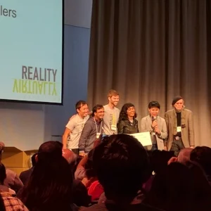Adrian Babilinski accepting an award at the Reality Virtually Hackathon.