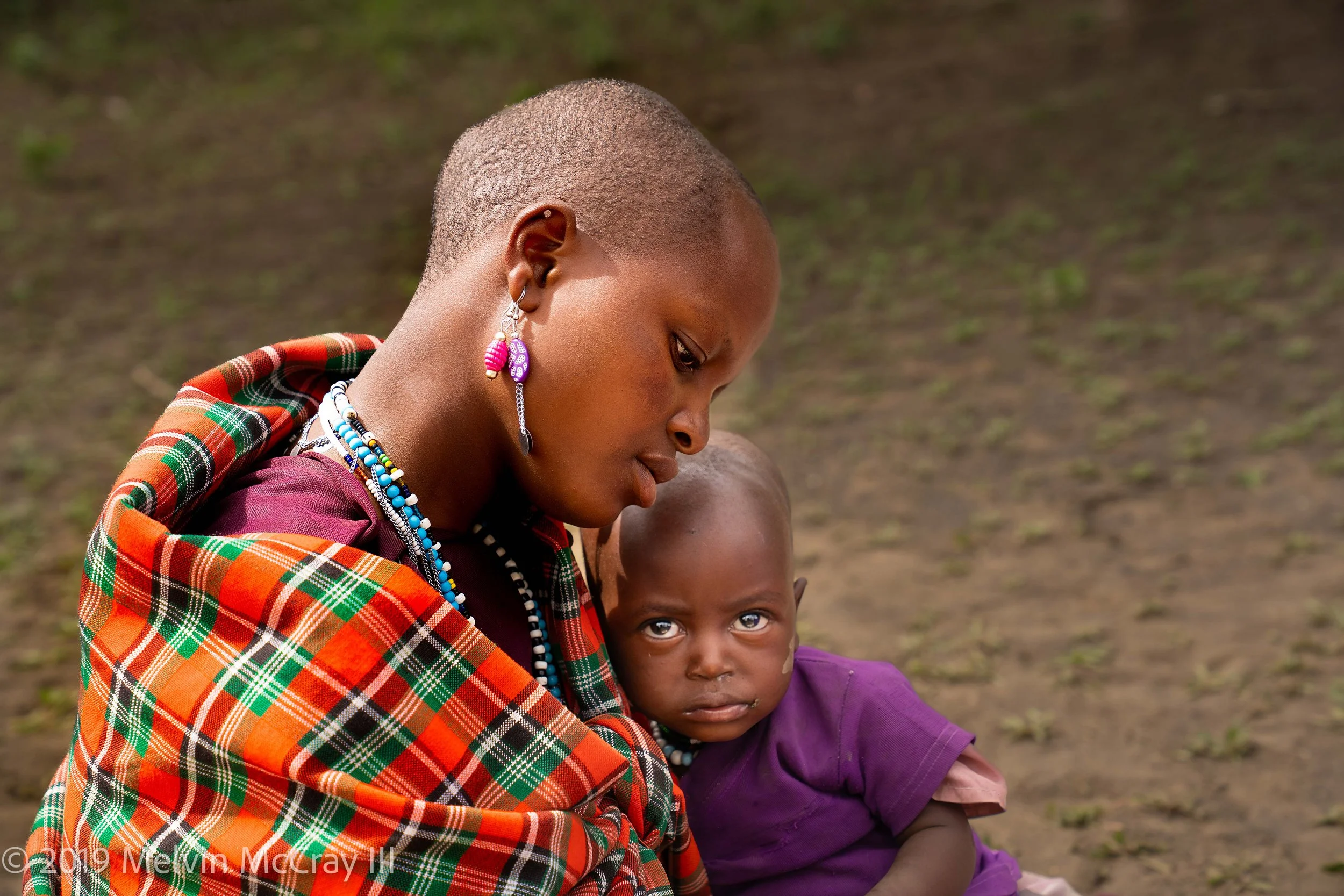 Maasai woman with baby in her lap.jpg