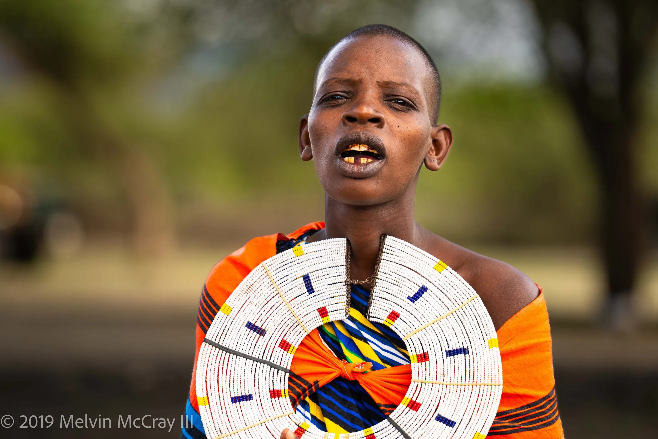 Maasai woman holding necklace.jpg