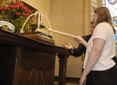 Heidi rings the bell in honor of her father at a memorial service at Mariner's Church in Detroit, Michigan.