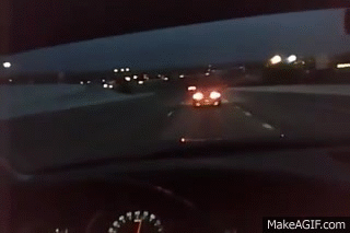 An Audi driving with its rear fog lights on.