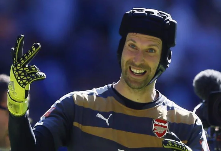 Plus, he wears a fun hat! PHOTO: http://metro.co.uk/2015/08/03/arsenal-fans-troll-chelsea-supporters-with-petr-cech-is-a-gooner-chant-5325083/