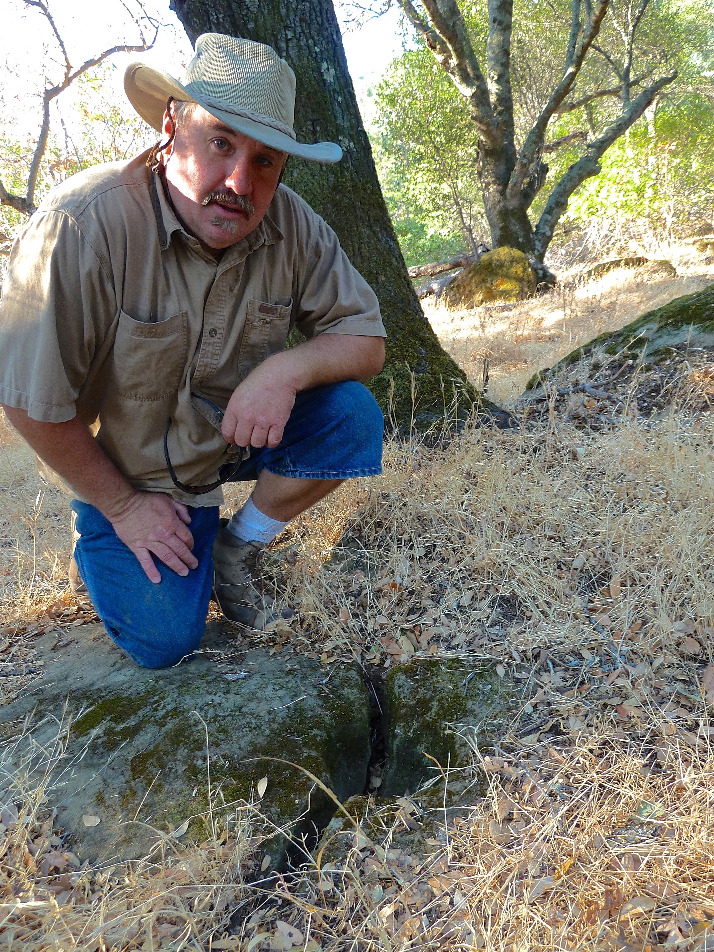 Scott Persson points out a Native American grinding stone off-trail in Los Vaqueros Watershed.