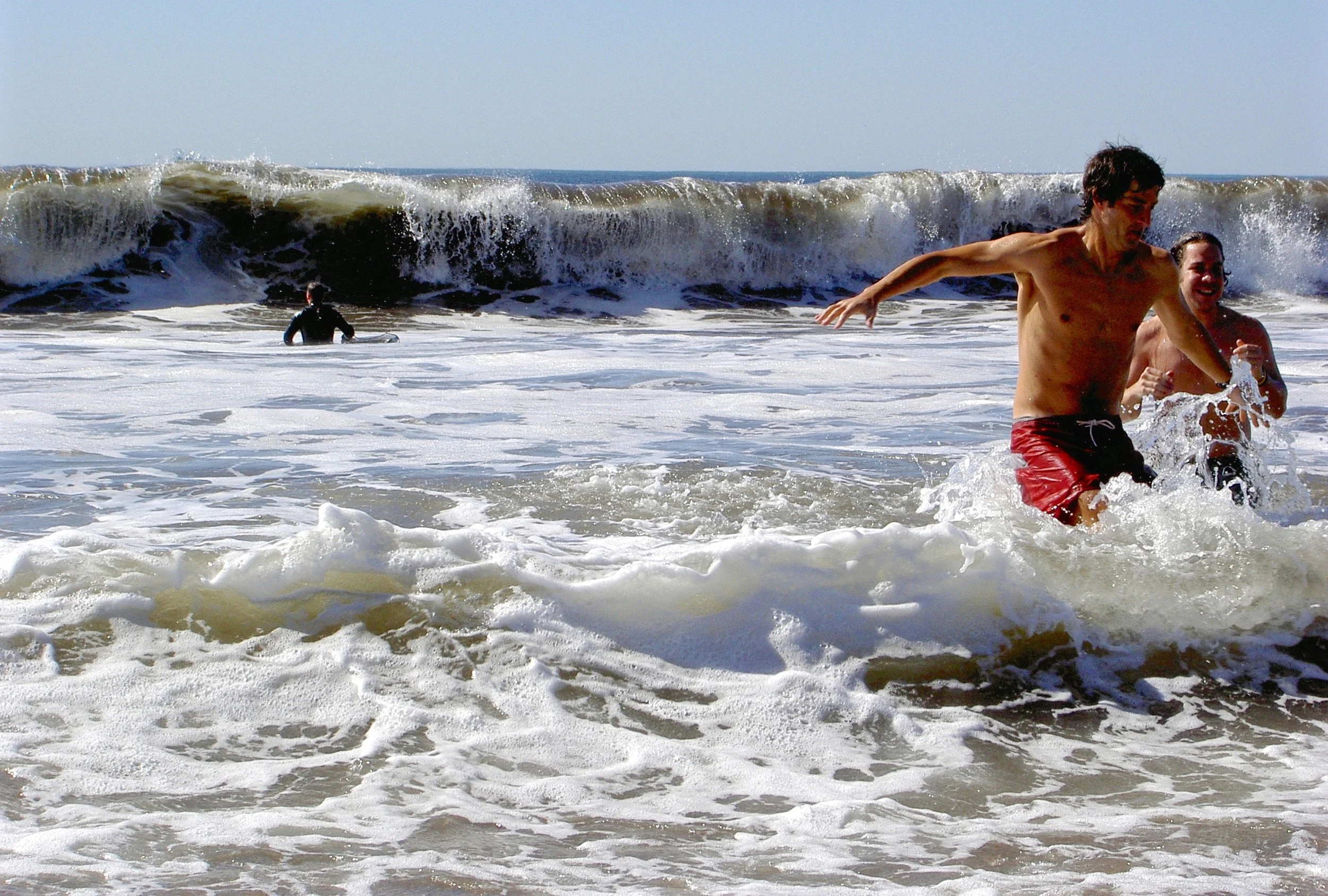 Boogie boarders ride the foam onto the Stinson beach shoreline.