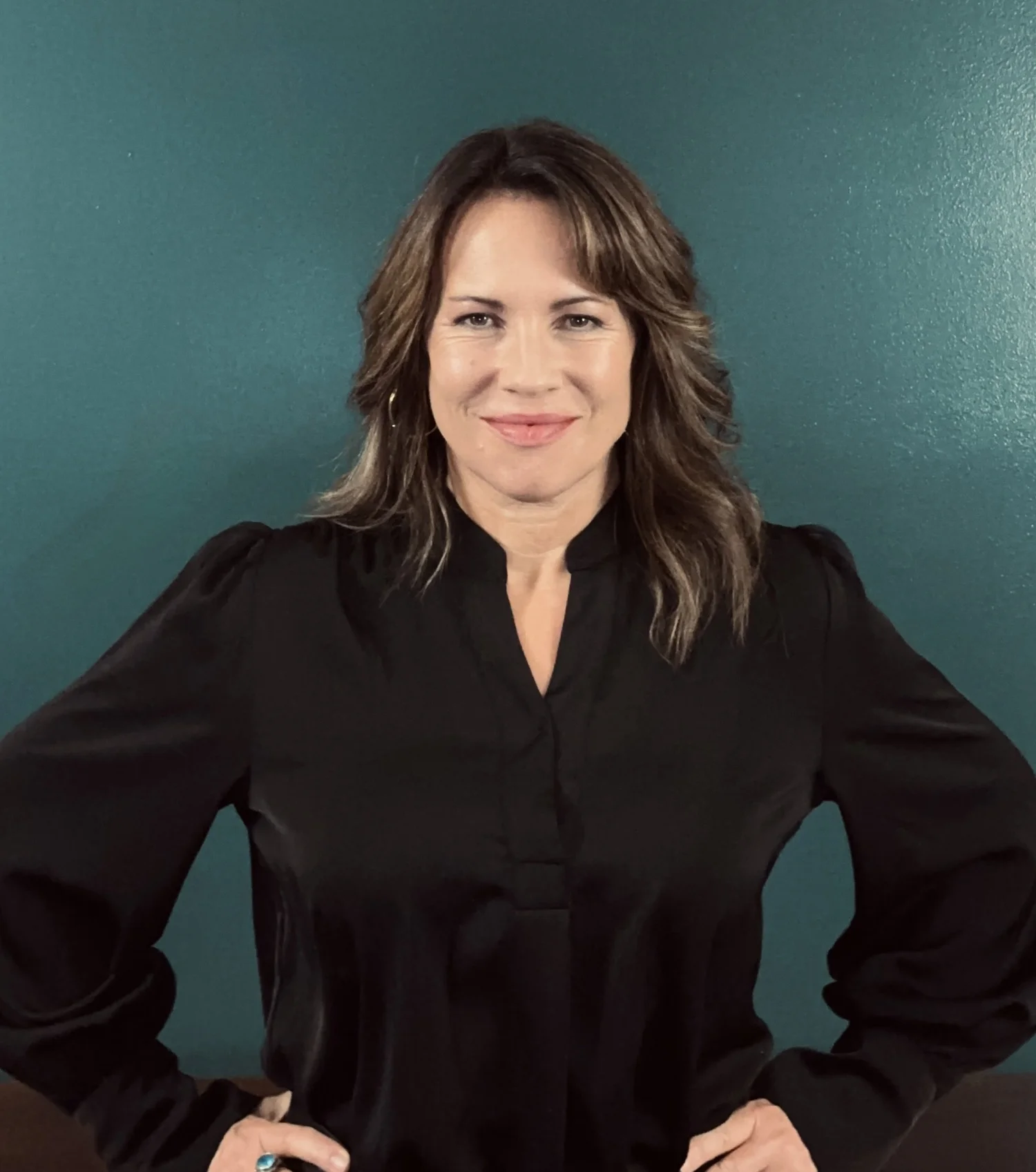 Jeni Ambrose, somatic leadership advisor, smiling directly at the camera