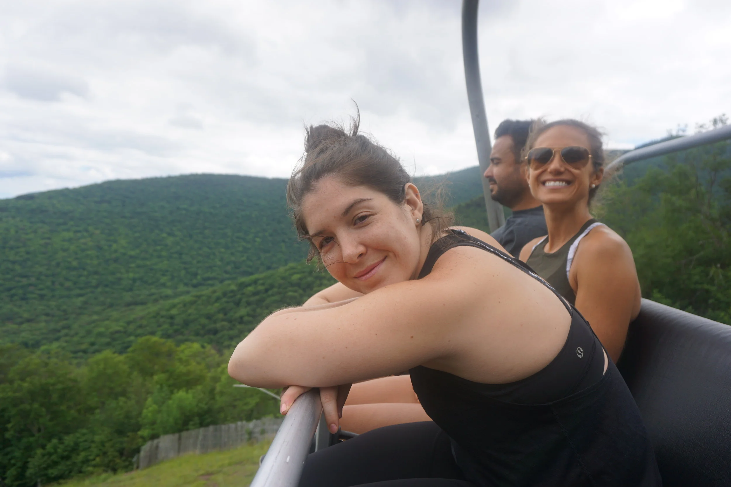 Nora, Jenn and Marcos riding the chairlift down after hiking to the top!