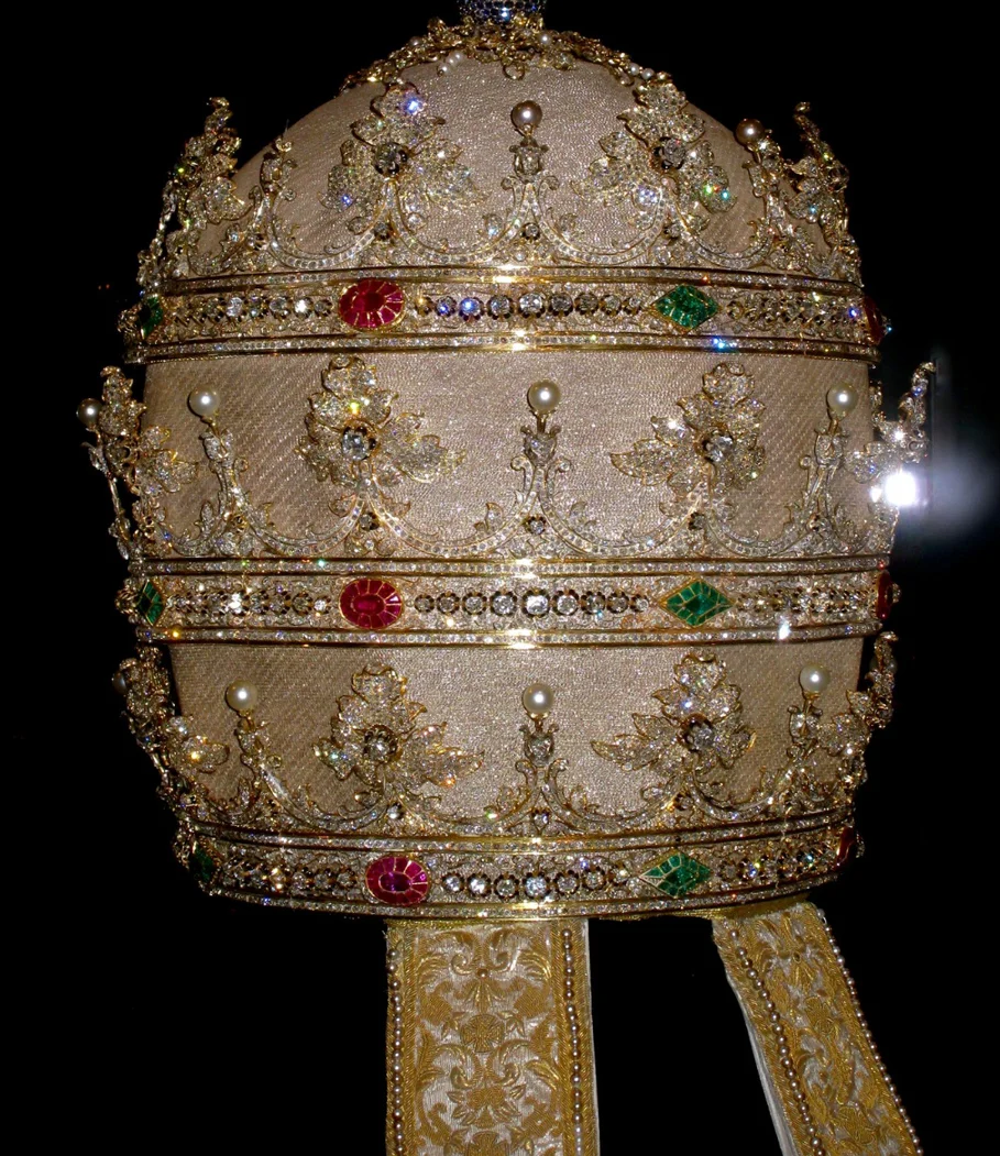 Tiara of Pius IX, (Reigned 1846–78); 1854 cloth of silver embroidered with gold metal thread, gold, diamonds, rubies, sapphires, emeralds, and pearls.