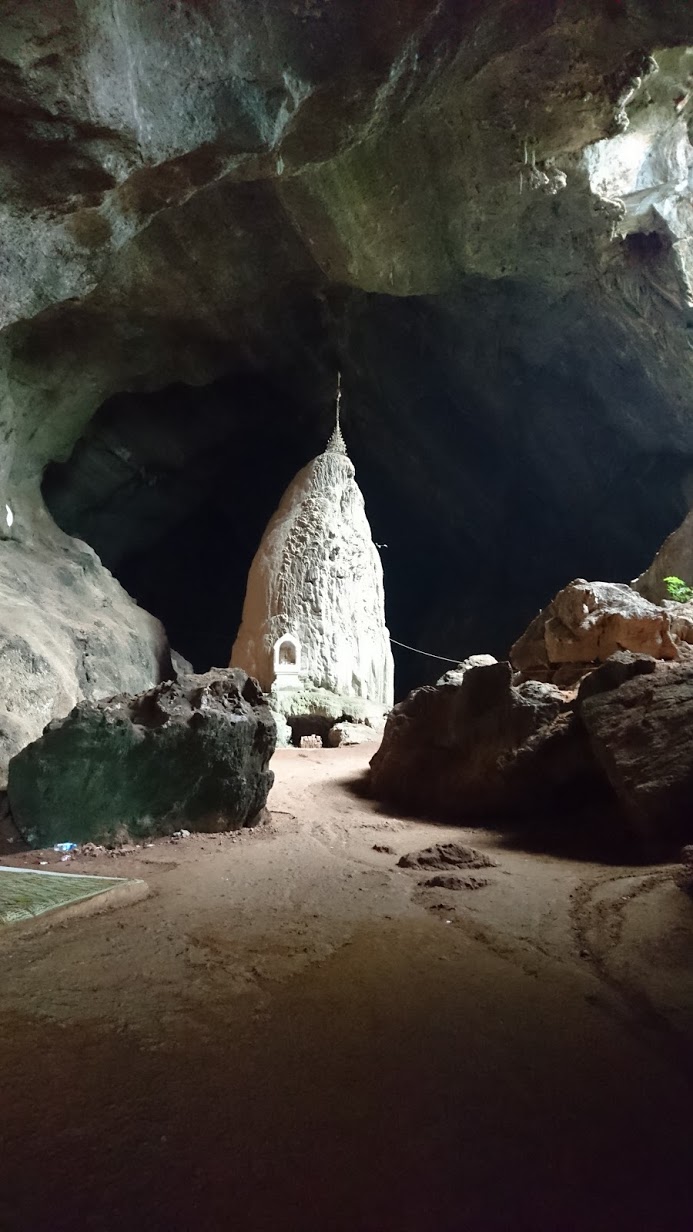 The Magic Carpet of Bat Poo leading us to a stone formation with a tiny golden pagoda at the top.