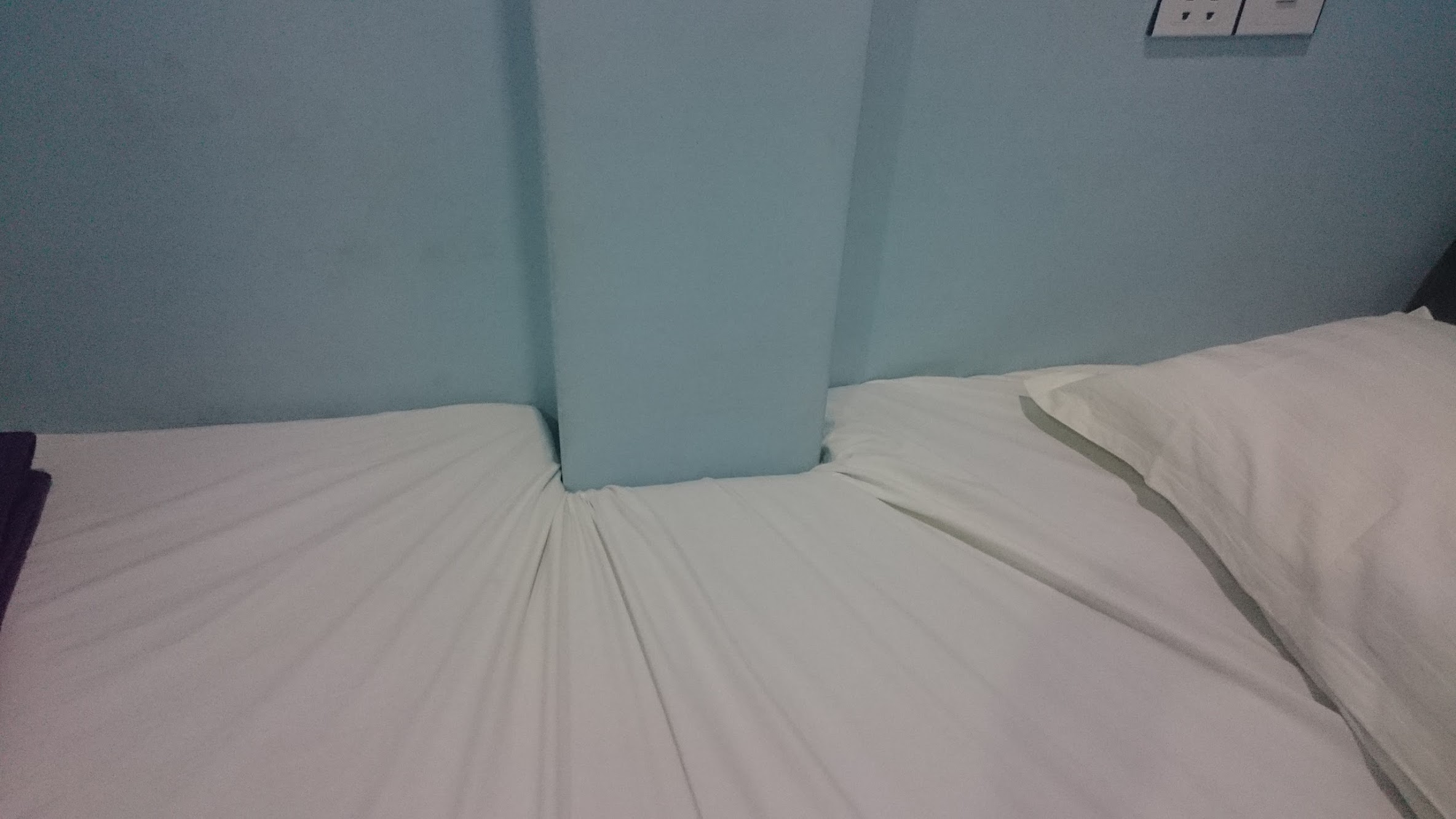 The room has its quirks, as we amusingly found when we discovered that our bed and sheet were cut to fit a protruding column on the wall. 