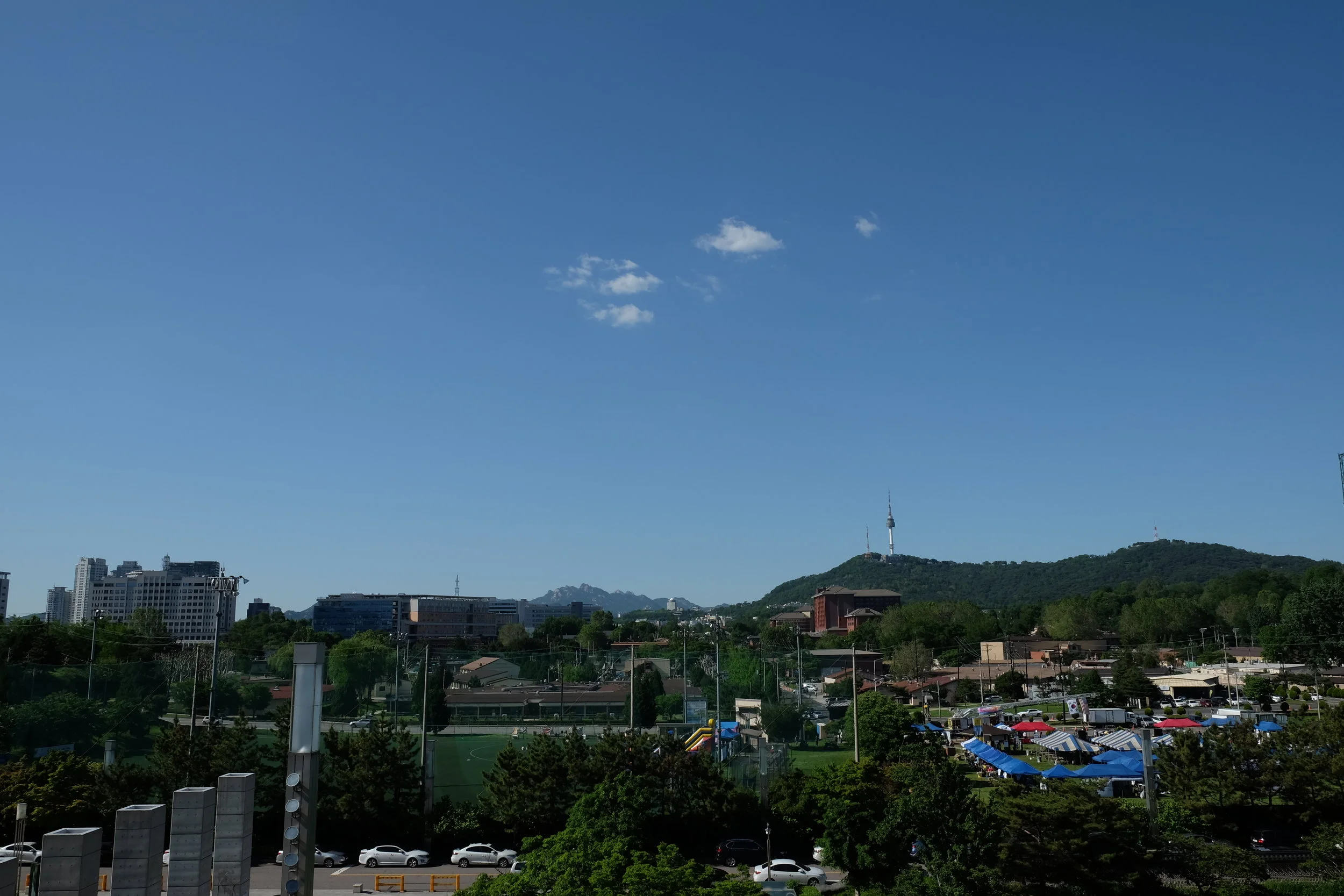 If you keep walking past the main building through the courtyard, you come across a balcony that offers views of N Seoul Tower and the surrounding mountains beyond the city.