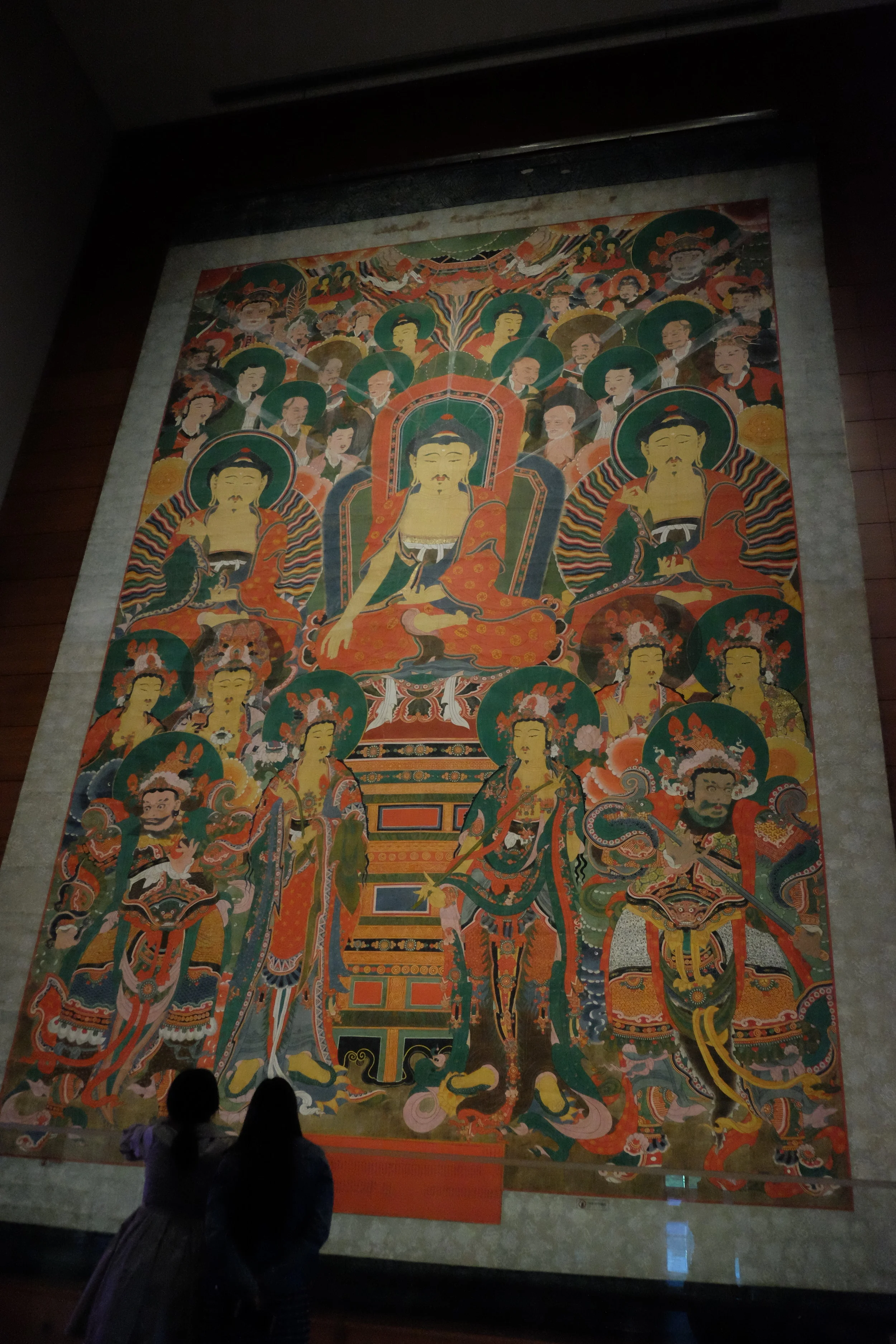 When we were there, the “Gathering of the Three Buddhas” exhibition was going on and boy, were we glad to see it. Normally hung in Yongheungsa Temple, this large-scale Buddhist hanging scroll depicts depicts a gathering of Śākyamuni Buddha, Bhaisajyaguru Buddha, and Amitābha Buddha hosted by Śākyamuni Buddha, the ruler of the secular world. People prayed to these three Buddhas for a long life free from illness, and hoped for a rebirth in the Western Paradise. To illustrate how tall it is, see the two women in the lower left for scale.