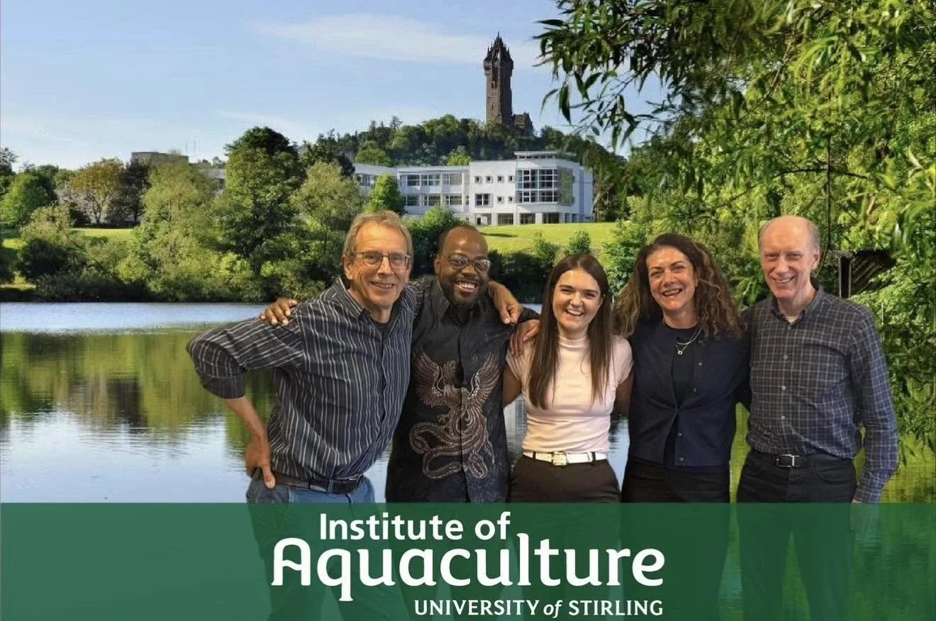 Photograph of the University of Stirling team. The background shows the University campus including Airthrey Loch, the administrative buildings and the Wallace Monument.