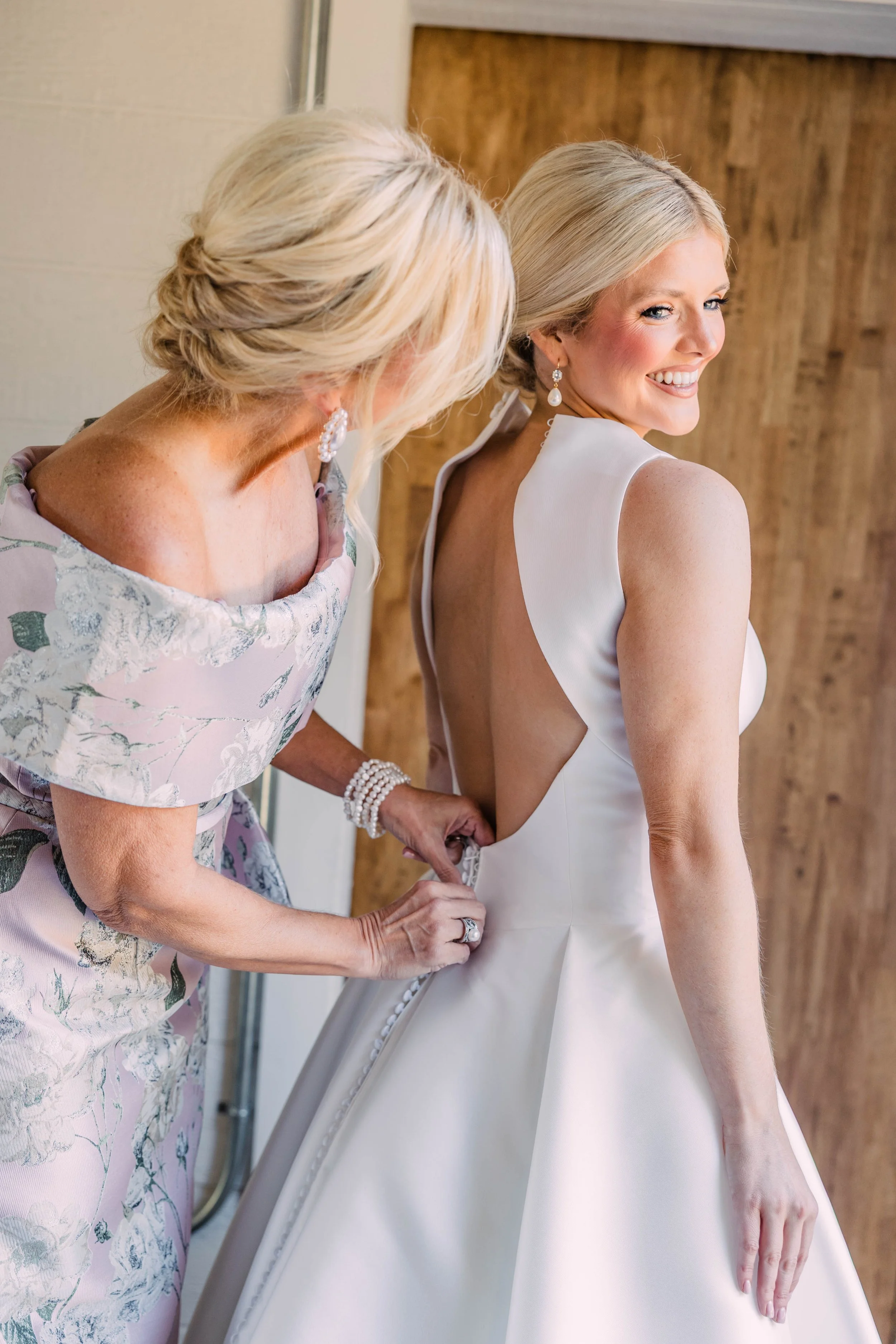 03-mother-buttoning-the-bride-s-gown-before-a-december-wedding-at-sainte.jpg