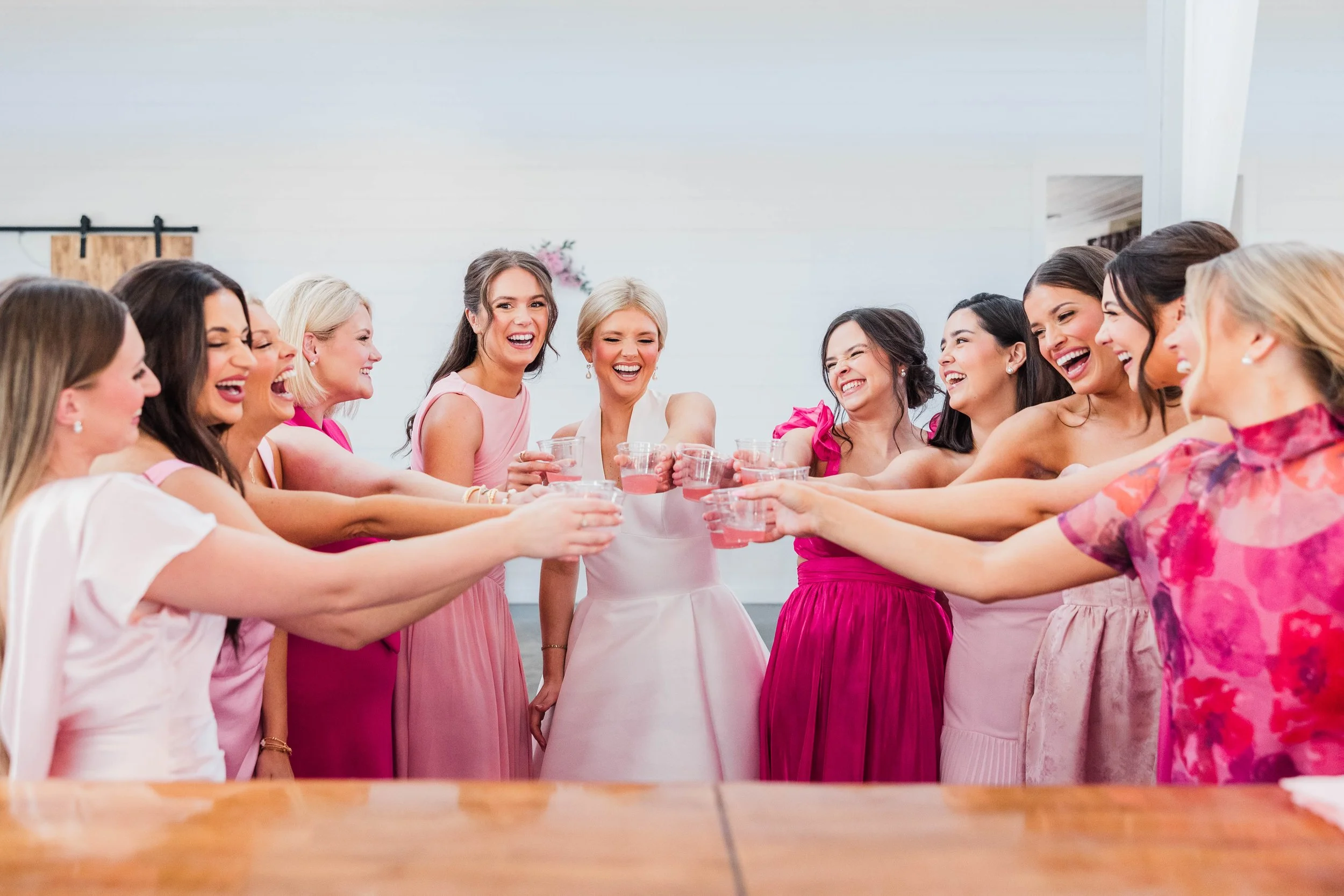 05-bridesmaids-toasting-in-pink-dresses-before-a-winter-wedding-at-sainte.jpg