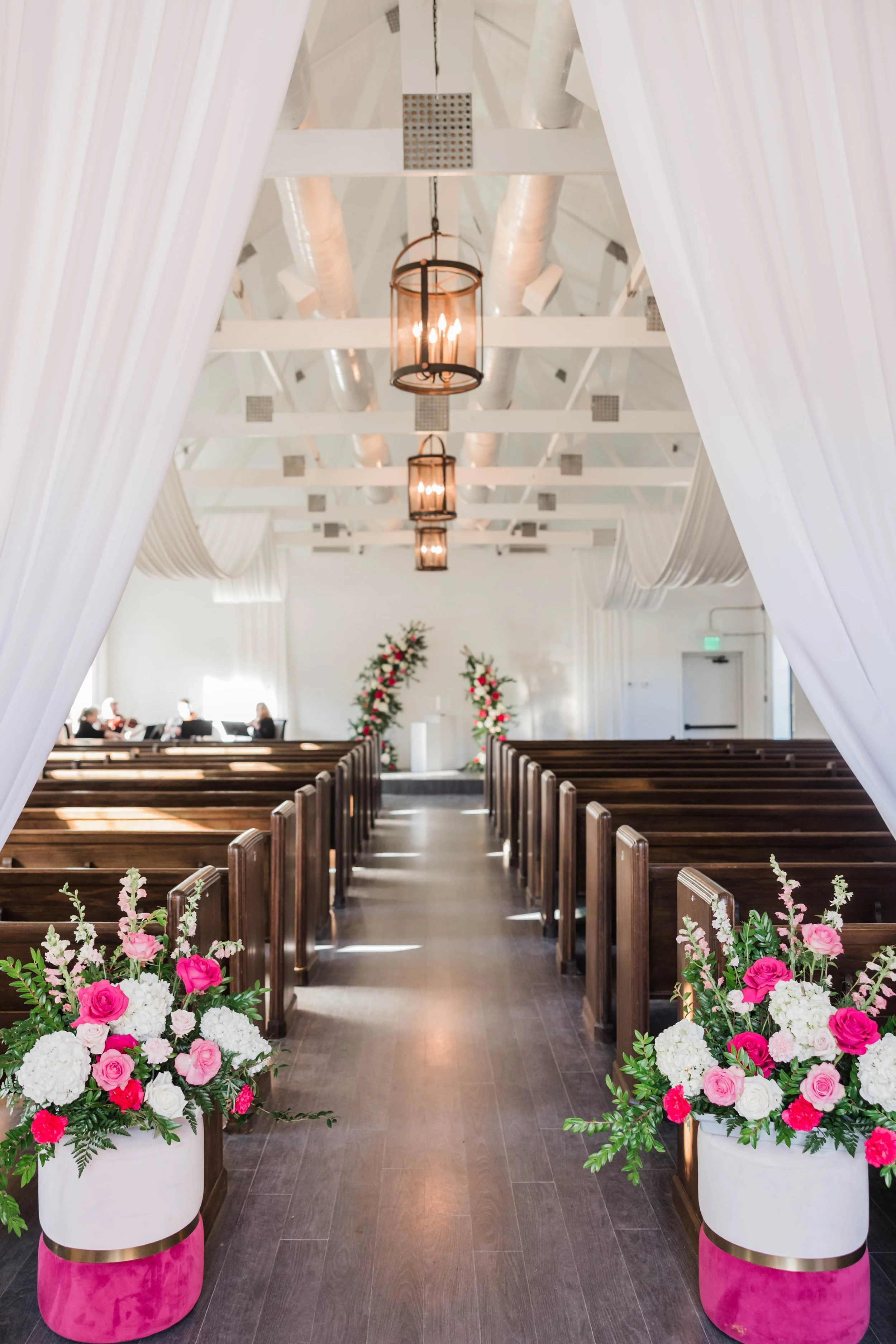 07-wedding-ceremony-aisle-in-the-white-chapel-at-the-stone-barn-with-hot.jpg