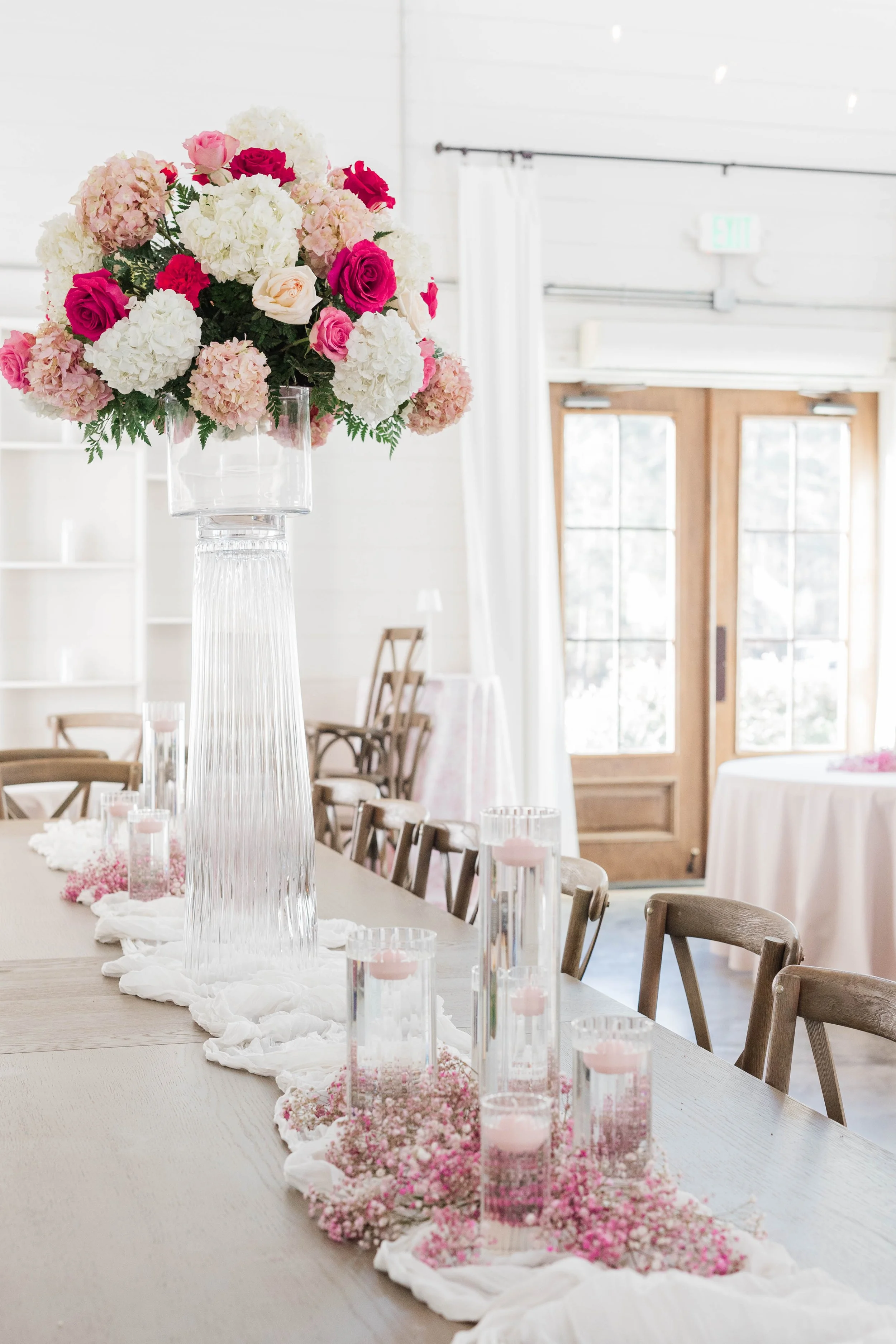 09-aisle-lined-with-tall-pink-florals-and-petals-in-the-chapel-at-the.jpg
