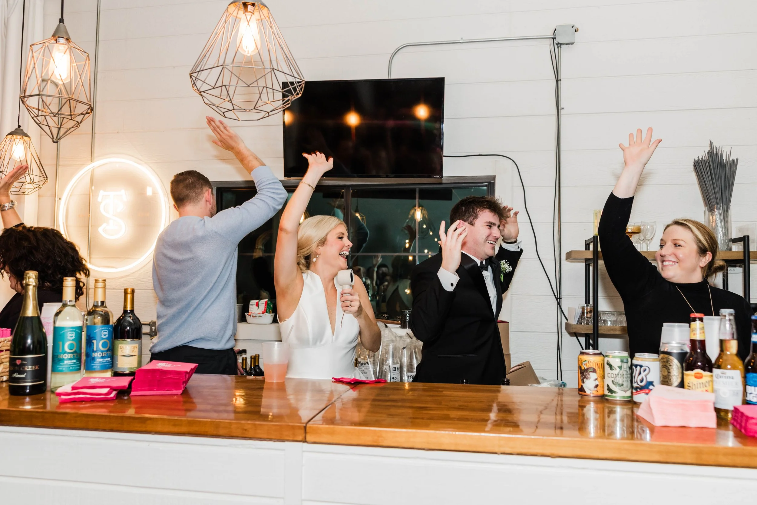 16-bride-and-groom-behind-the-bar-with-the-sainte-terre-team-during-the.jpg