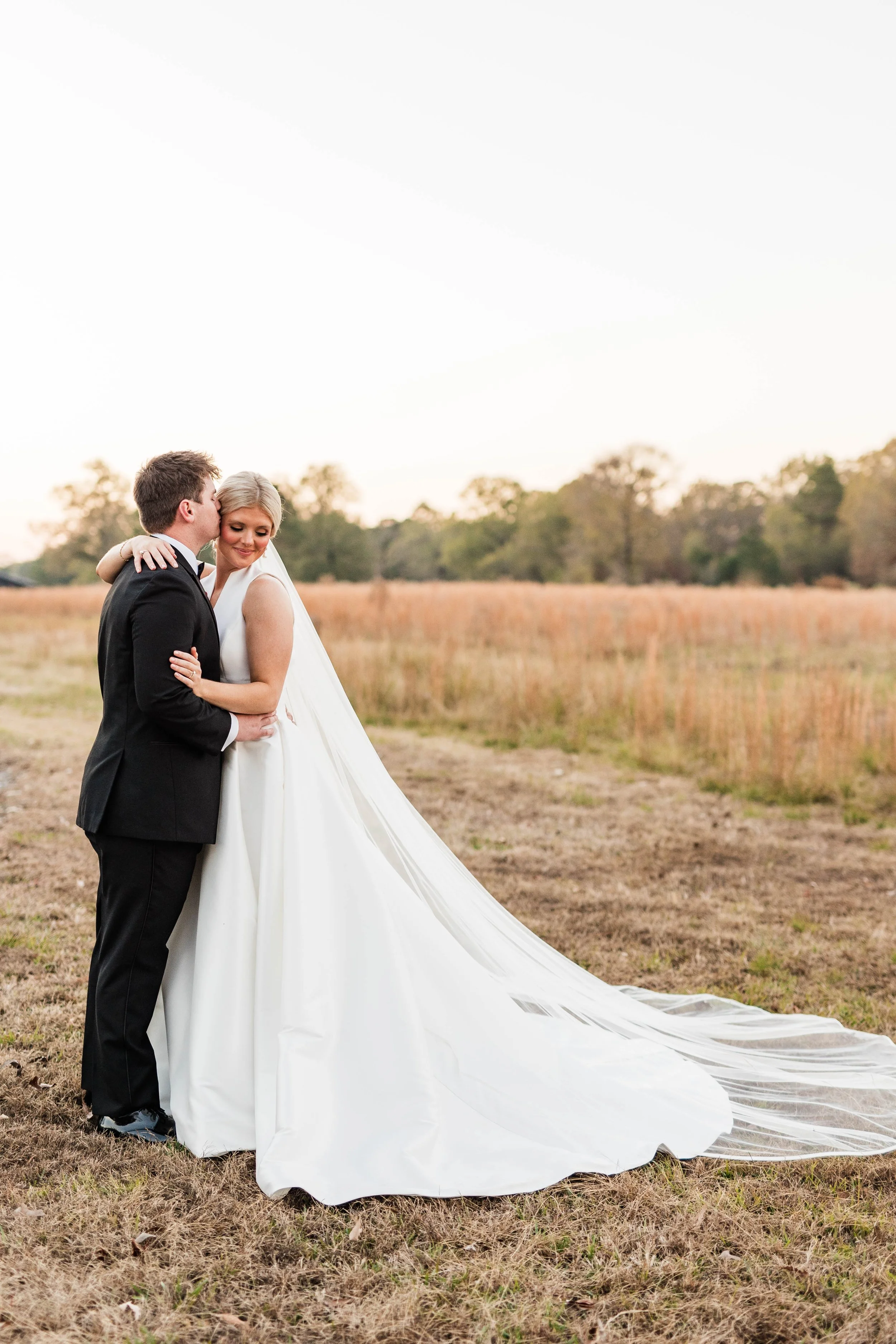 19-bride-and-groom-in-the-golden-december-field-at-sainte-terre-benton.jpg