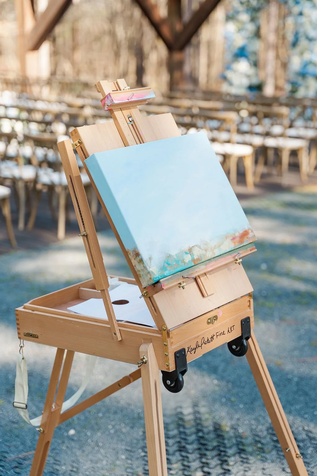 08-live-wedding-painter-s-easel-at-the-edge-of-the-pines-at-the-sanctuary.jpg