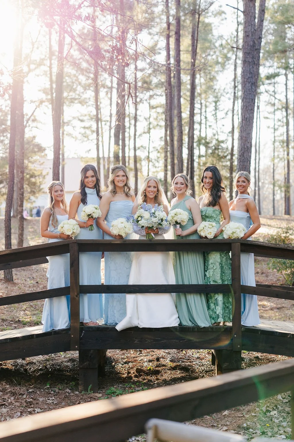 12-bridal-party-in-blue-and-green-on-the-bridge-among-the-pines-at-sainte.jpg
