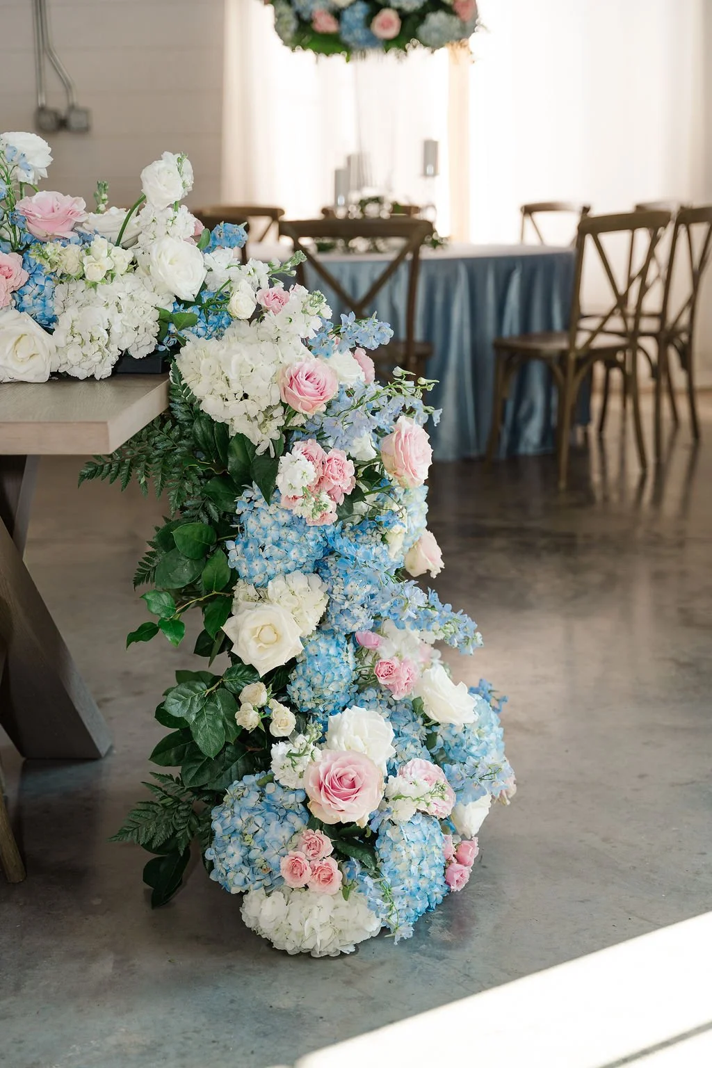 15-floral-column-of-blue-hydrangea-blush-and-white-roses-at-a-sainte-terre.jpg