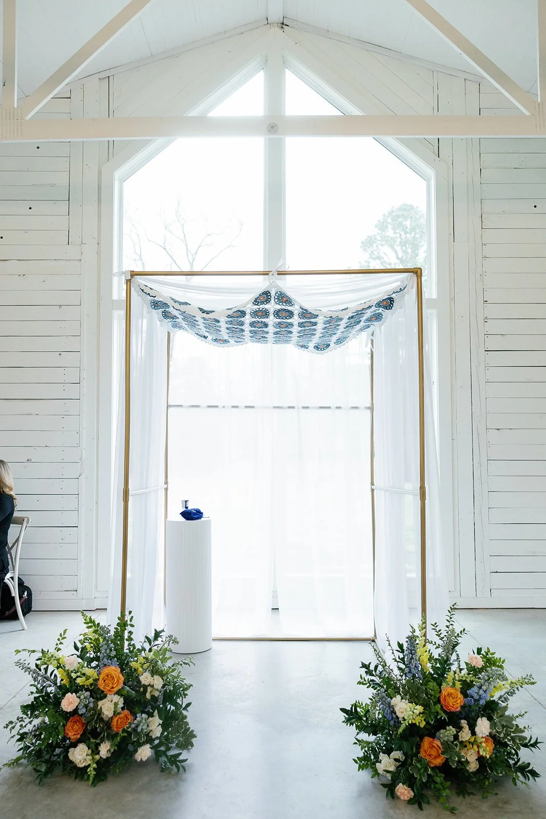 04-chuppah-with-peach-and-blue-florals-in-the-chapel-at-the-stables-at.jpg
