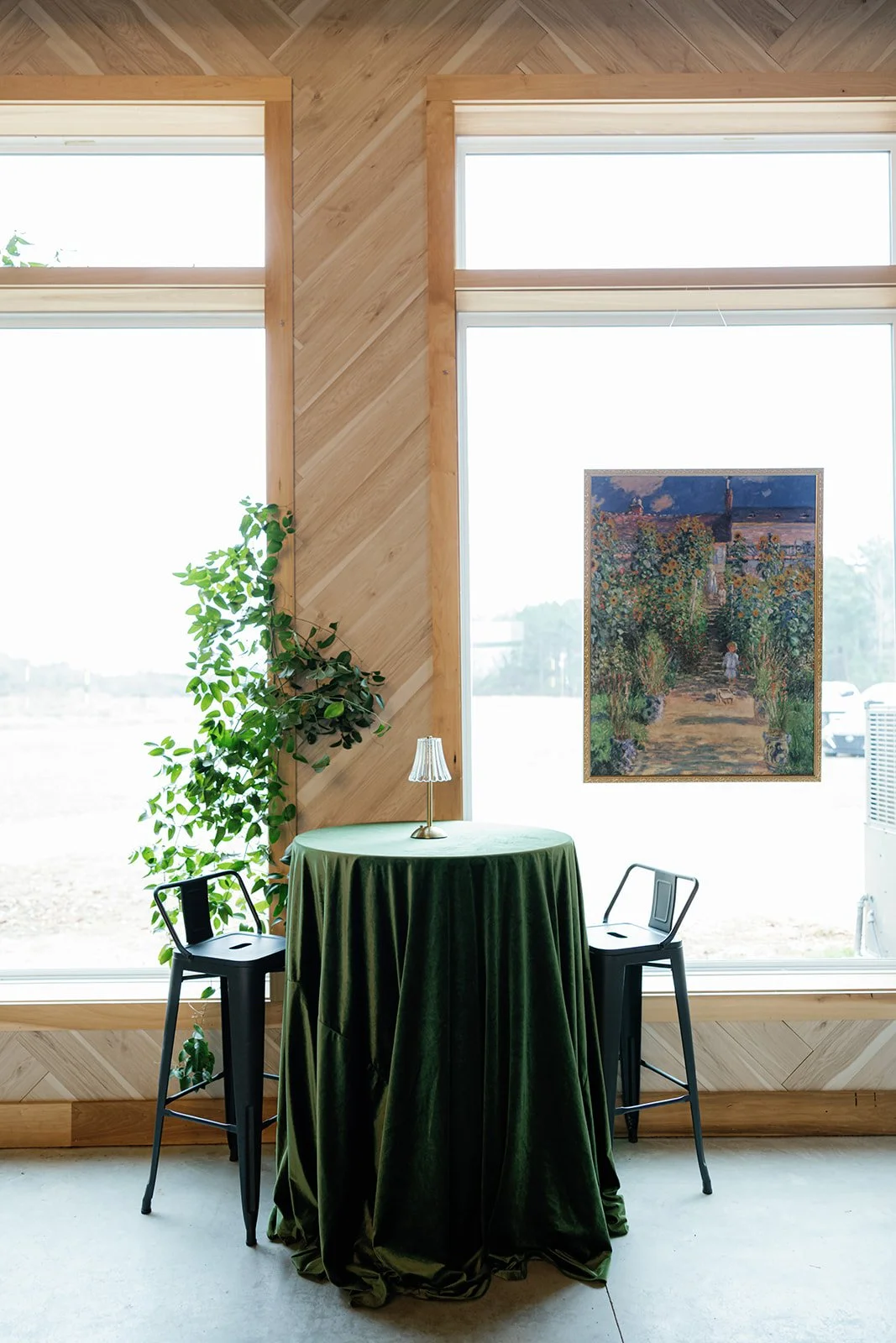 04-green-velvet-cocktail-table-beneath-a-hung-painting-at-the-stables.jpg