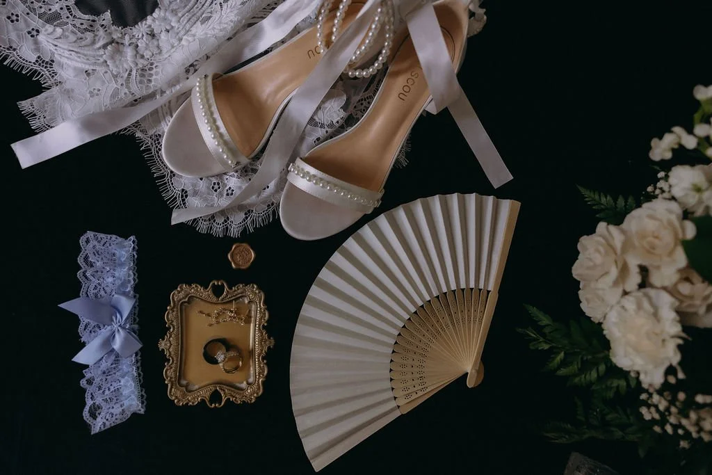 01-bridal-details-flat-lay-with-pearl-heels-a-gold-ring-tray-and-a-bamboo.jpg