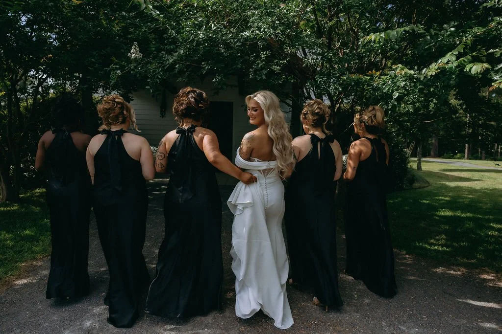 10-bride-in-white-with-six-bridesmaids-in-black-gowns-at-the-stone-barn-at.jpg