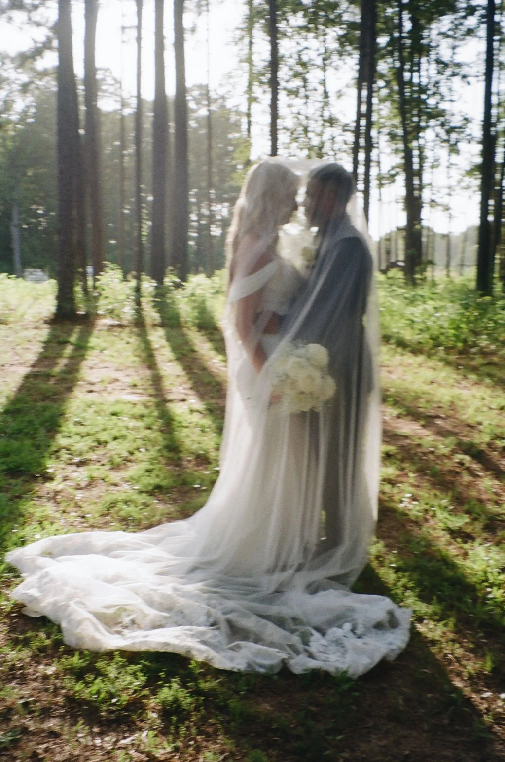 14-bride-and-groom-beneath-her-cathedral-veil-in-the-pines-at-sainte-terre.jpg
