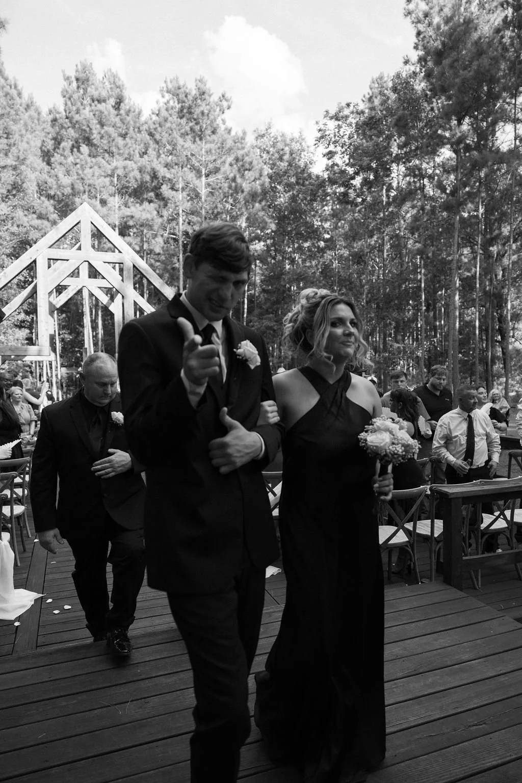 18-groomsman-and-bridesmaid-in-black-walking-out-of-the-sanctuary-at.jpg