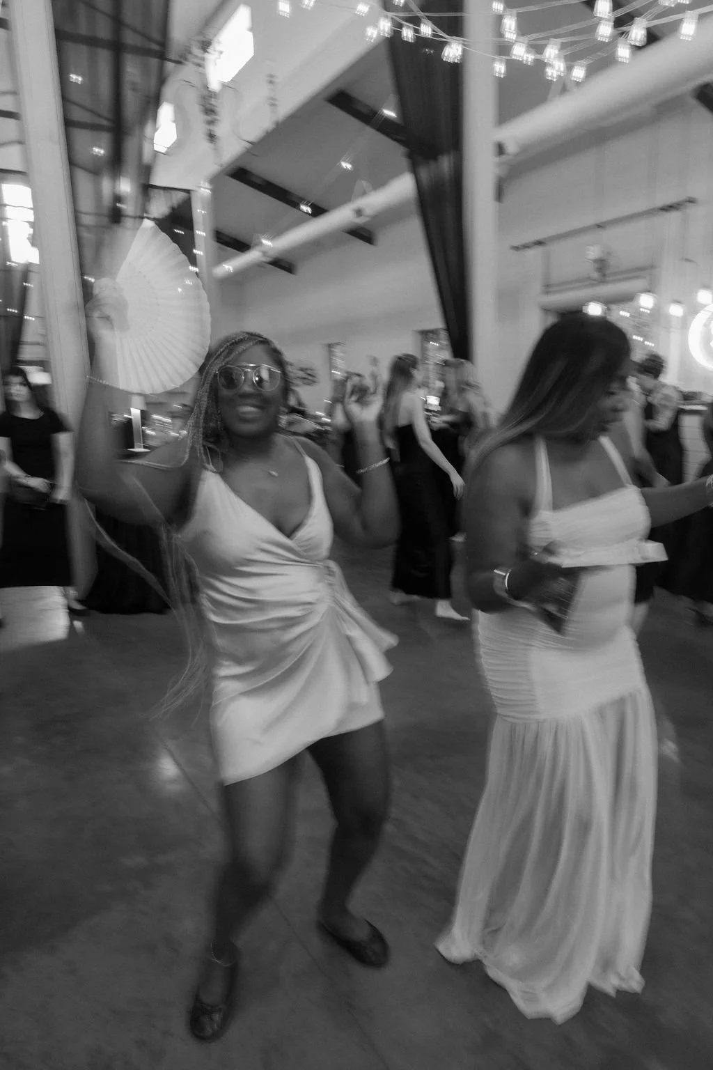28-black-and-white-photograph-of-a-guest-dancing-with-a-bamboo-fan-at-the.jpg