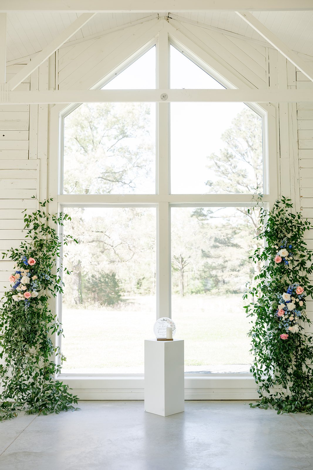 03-white-chapel-ceremony-backdrop-with-greenery-vines-climbing-the-walls.jpg