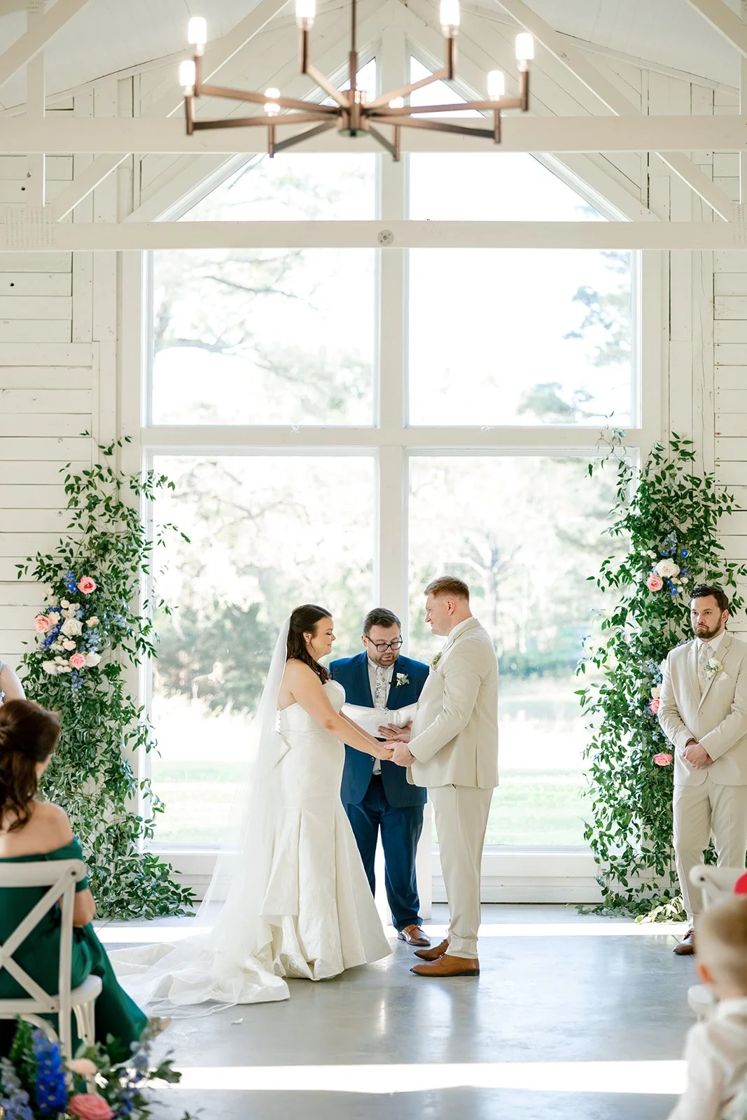 10-bride-and-groom-exchanging-vows-between-greenery-installations-in-the.jpg