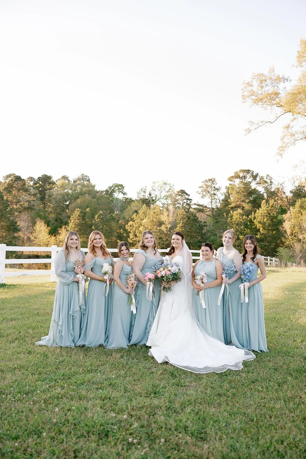 14-eight-bridesmaids-in-dusty-blue-gowns-at-golden-hour-at-the-stables-at.jpg