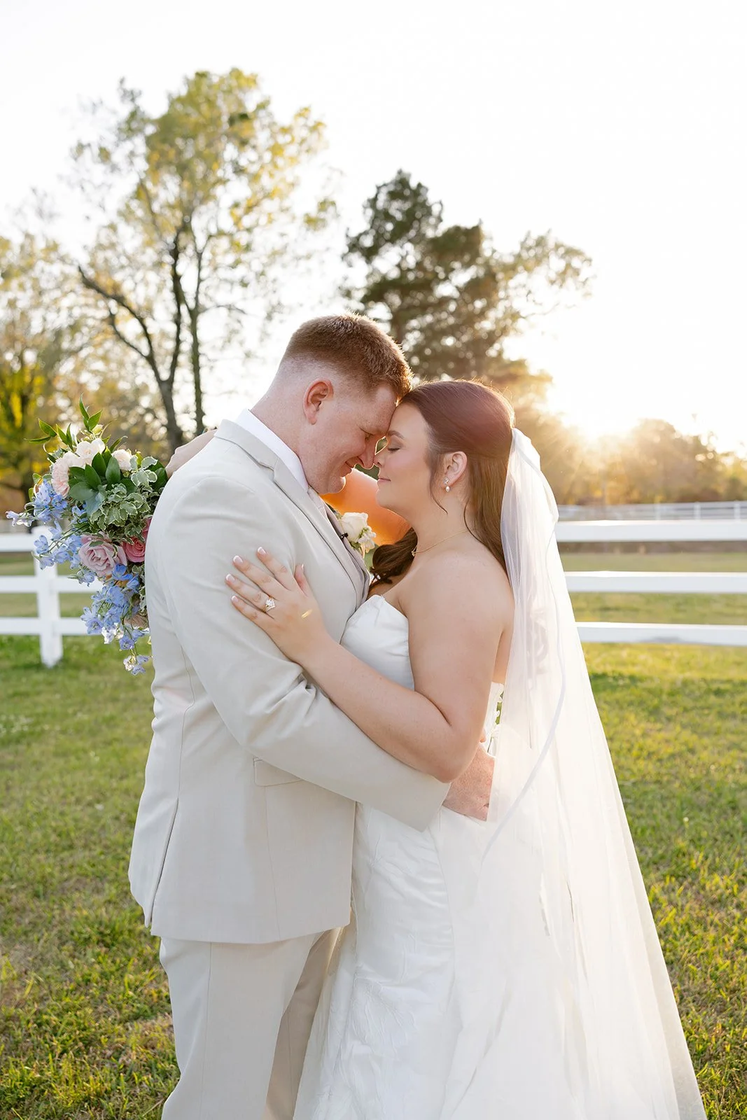 15-bride-and-groom-at-golden-hour-by-the-white-fence-at-the-stables-at.jpg