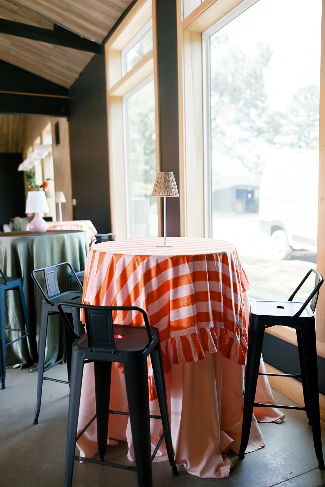 05-orange-striped-cocktail-tables-with-rattan-lamps-at-a-june-wedding-at.jpg