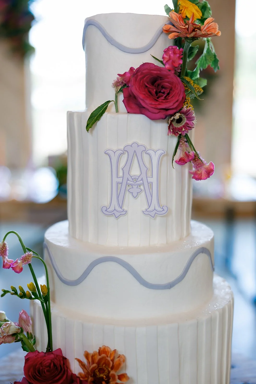06-four-tier-white-wedding-cake-with-lilac-monogram-and-bright-fresh.jpg