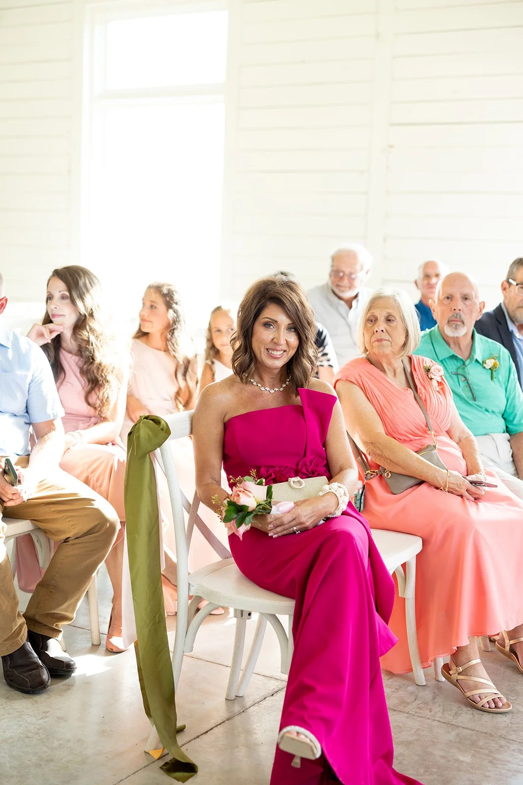 08-mother-of-the-couple-in-magenta-watching-the-ceremony-at-the-stables-at.jpg