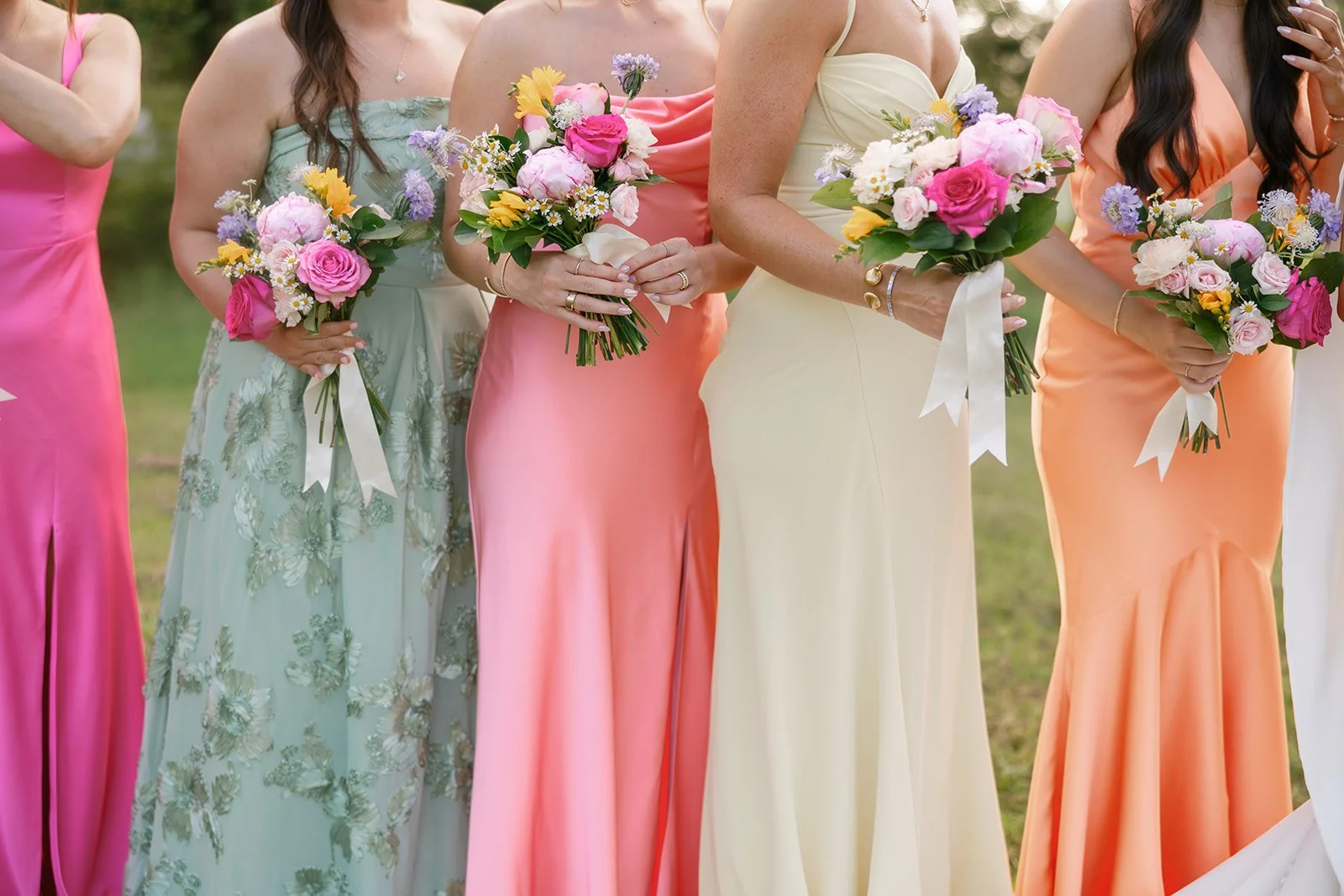 10-bridesmaids-in-mismatched-pink-coral-sage-and-yellow-holding-bright.jpg