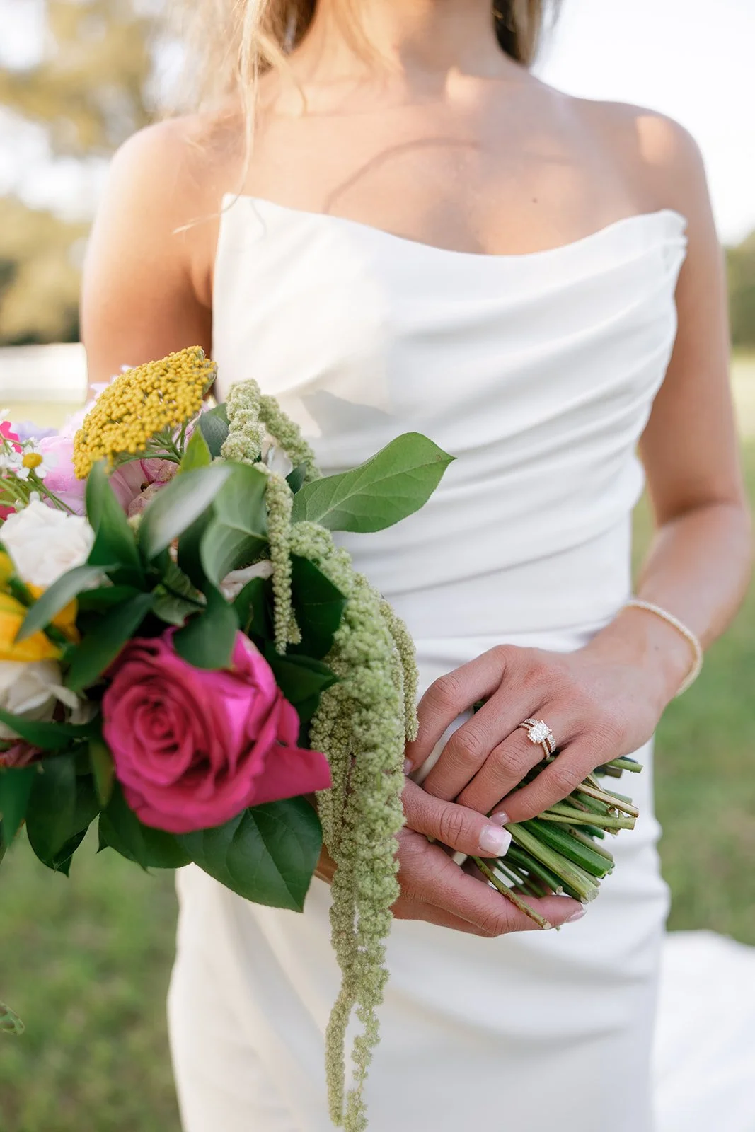 11-bride-in-white-matte-satin-holding-a-bouquet-of-hot-pink-roses-and.jpg