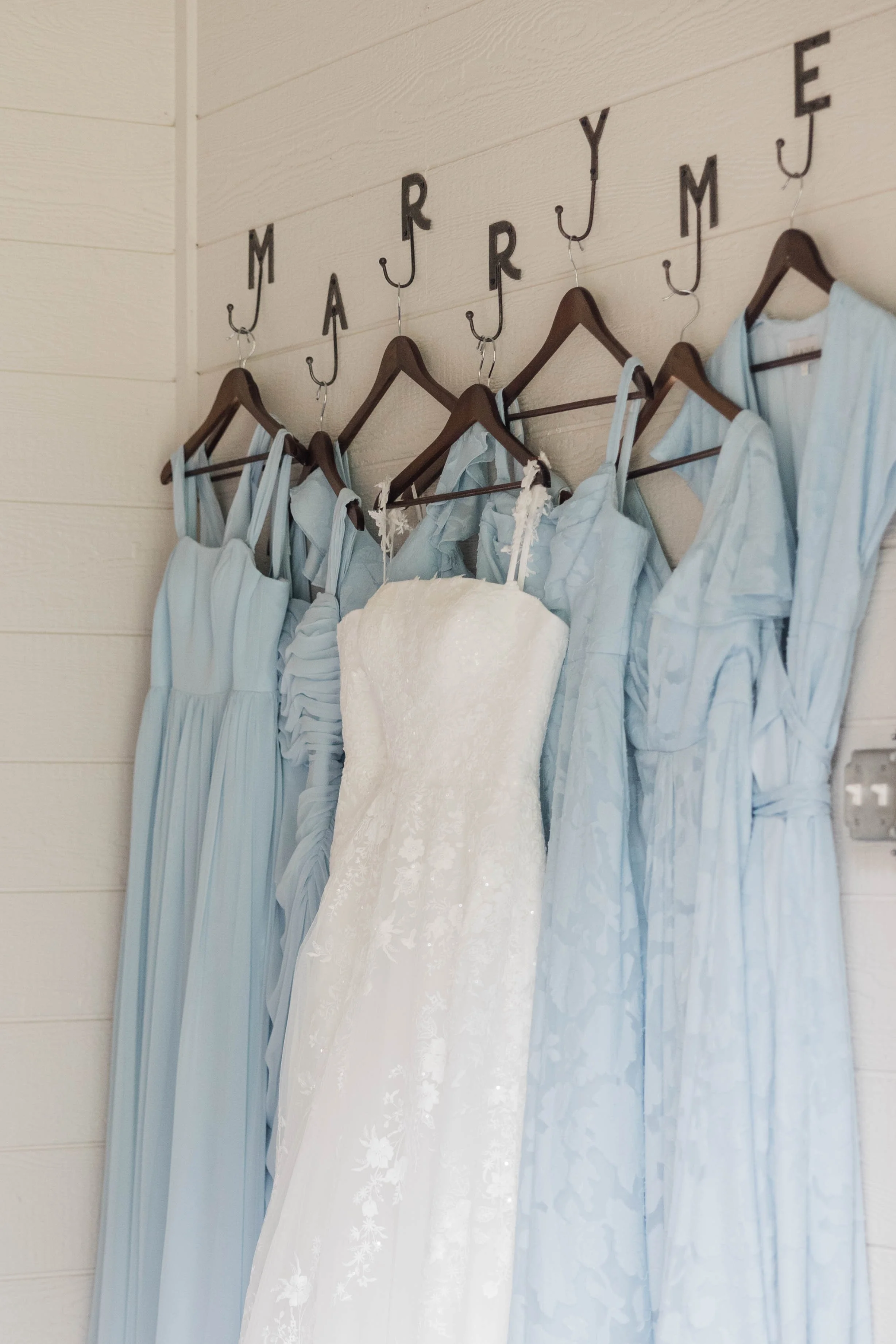 02-light-blue-bridesmaid-dresses-hanging-with-the-wedding-gown-in-the.jpg