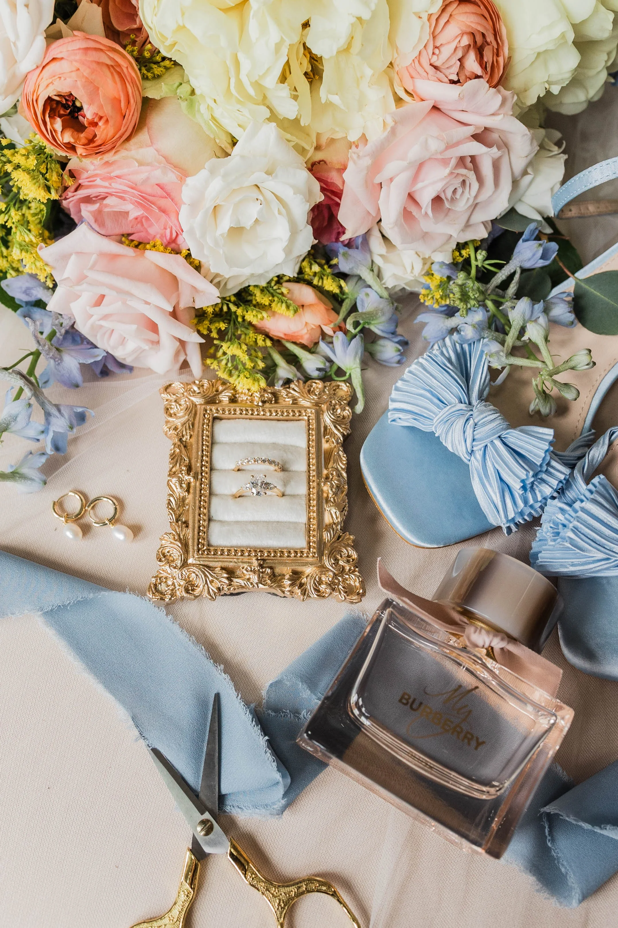 01-pastel-wedding-flat-lay-with-light-blue-bow-heels-gold-ring-box-and-a.jpg