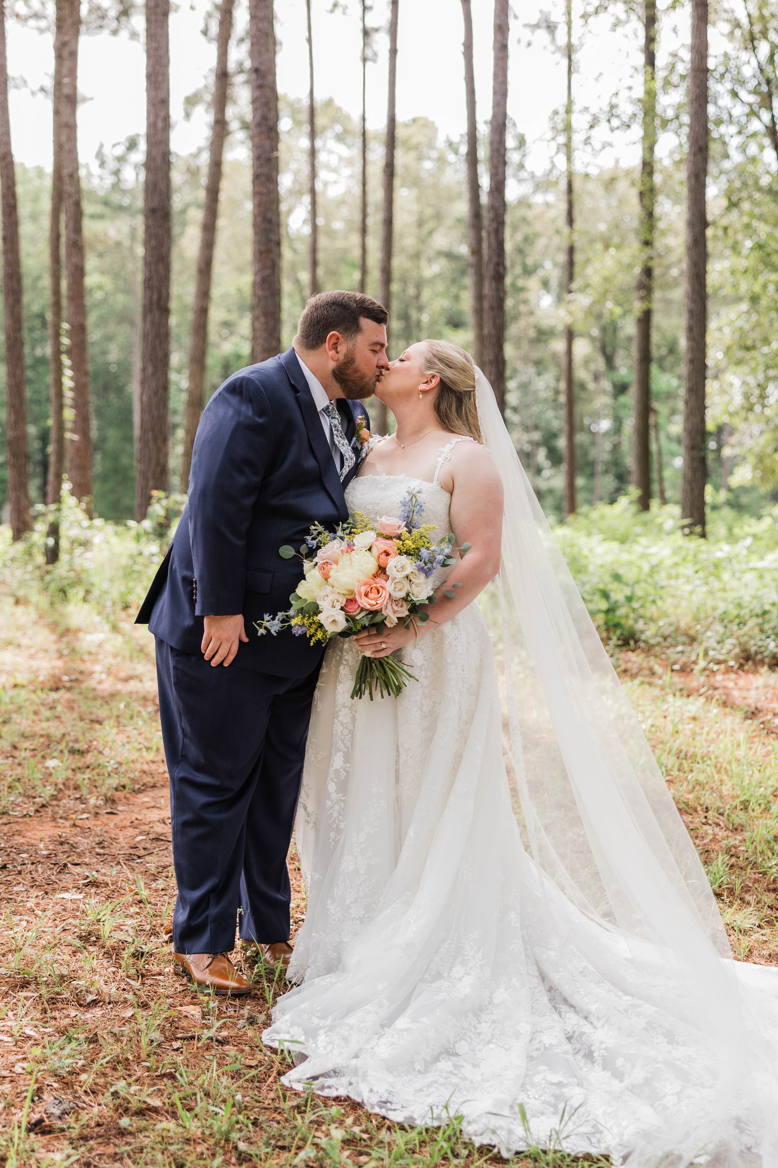 06-bride-and-groom-kissing-among-the-pines-after-their-ceremony-at-the.jpg