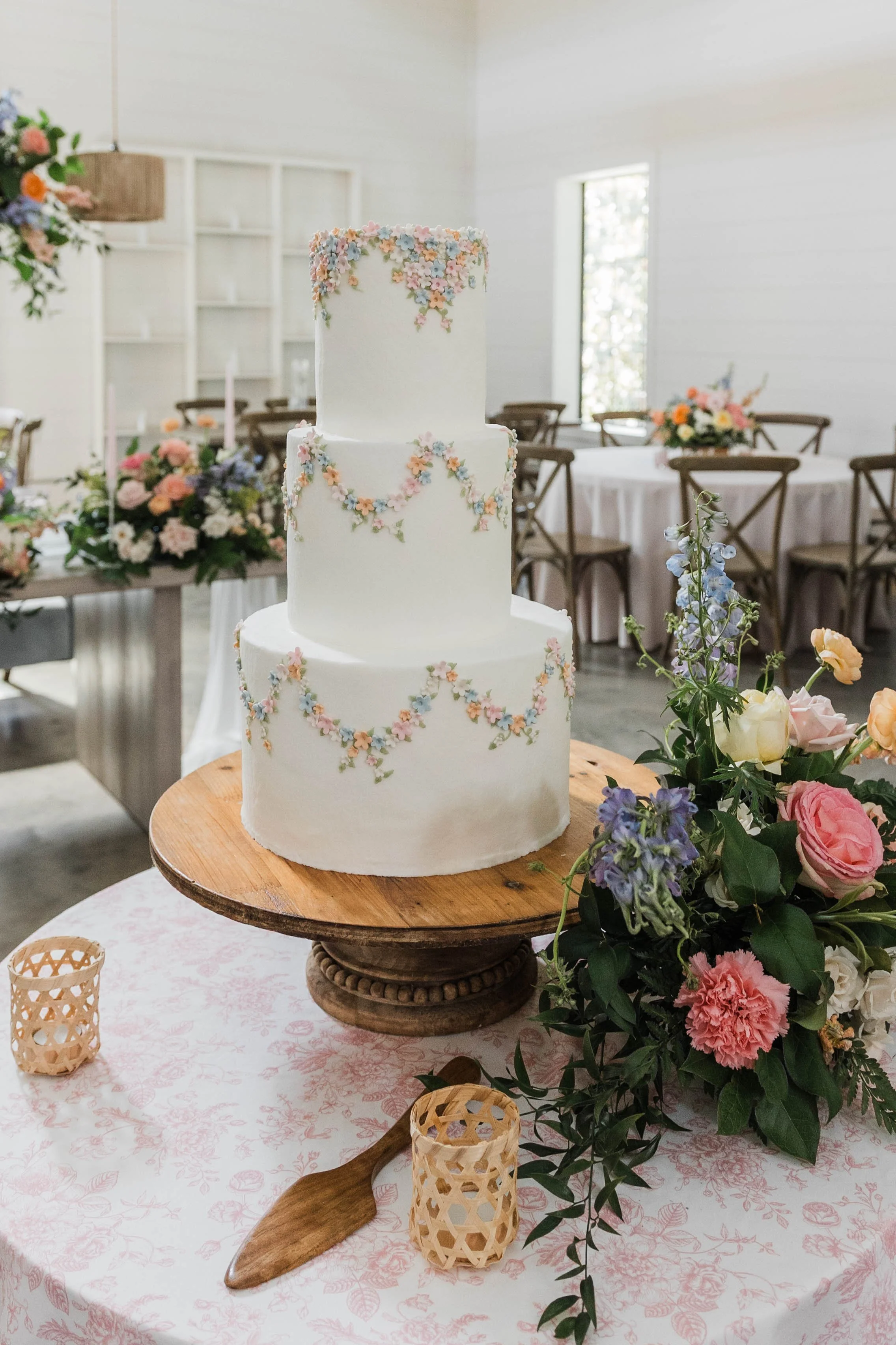08-three-tier-wedding-cake-covered-in-hand-piped-pastel-sugar-flowers-at.jpg