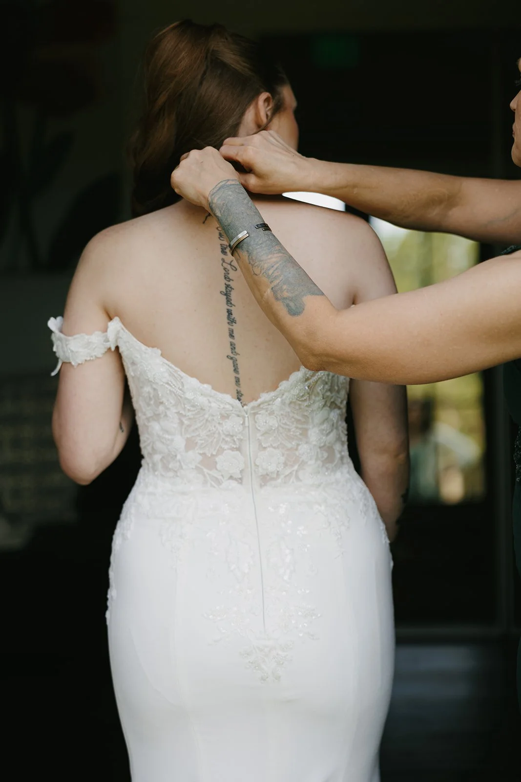 07-lace-back-of-the-wedding-gown-being-fastened-before-the-ceremony-at-the.jpg