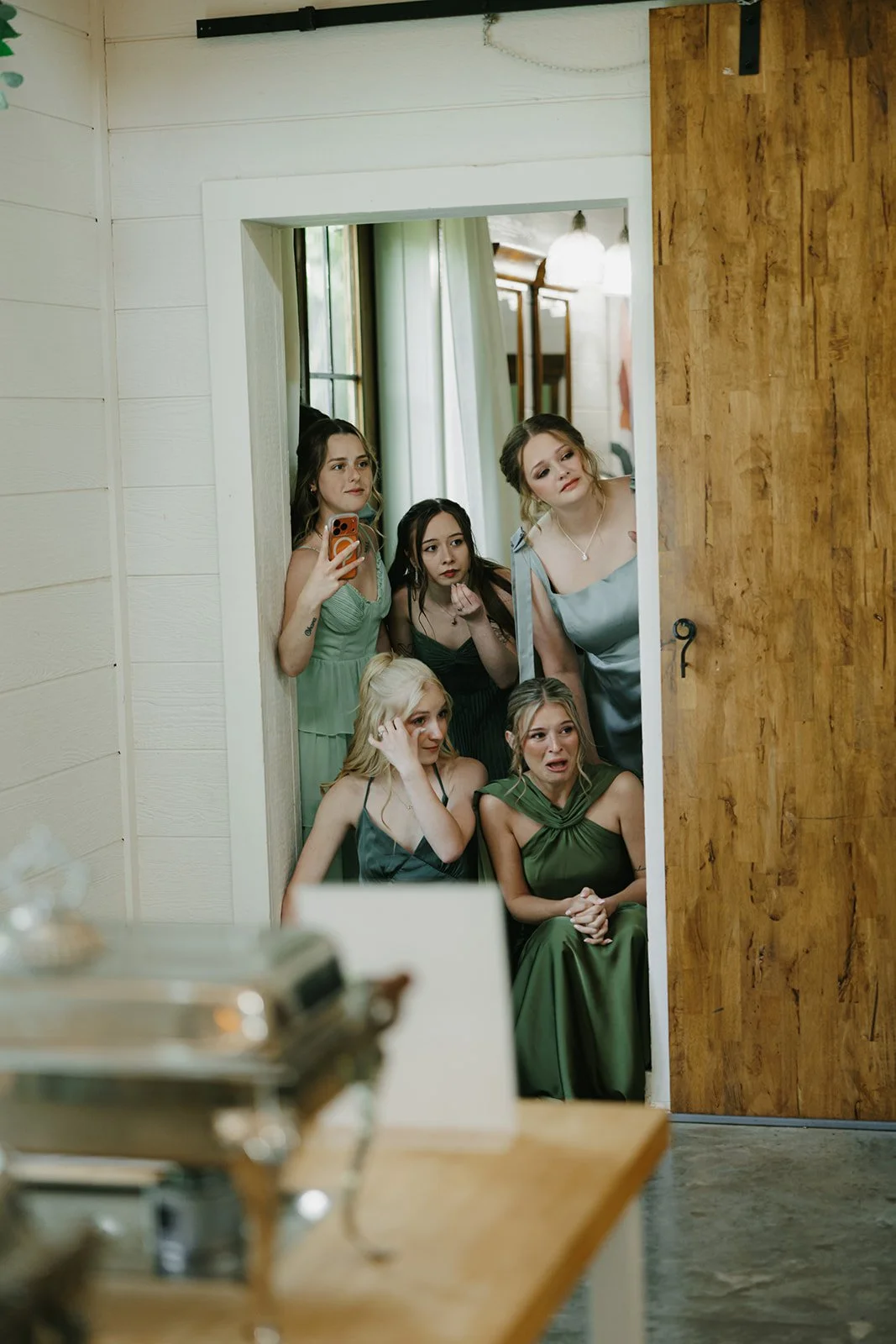 10-bridesmaids-in-green-dresses-watching-from-a-doorway-with-happy-tears.jpg