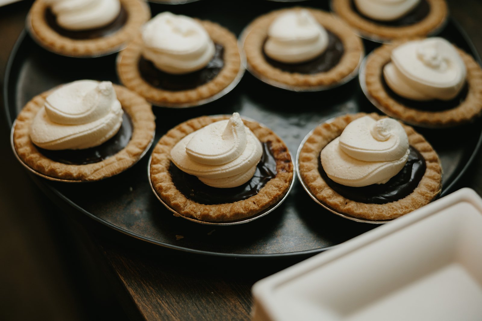 24-mini-chocolate-ganache-pies-topped-with-whipped-cream-at-a-wedding-at.jpg