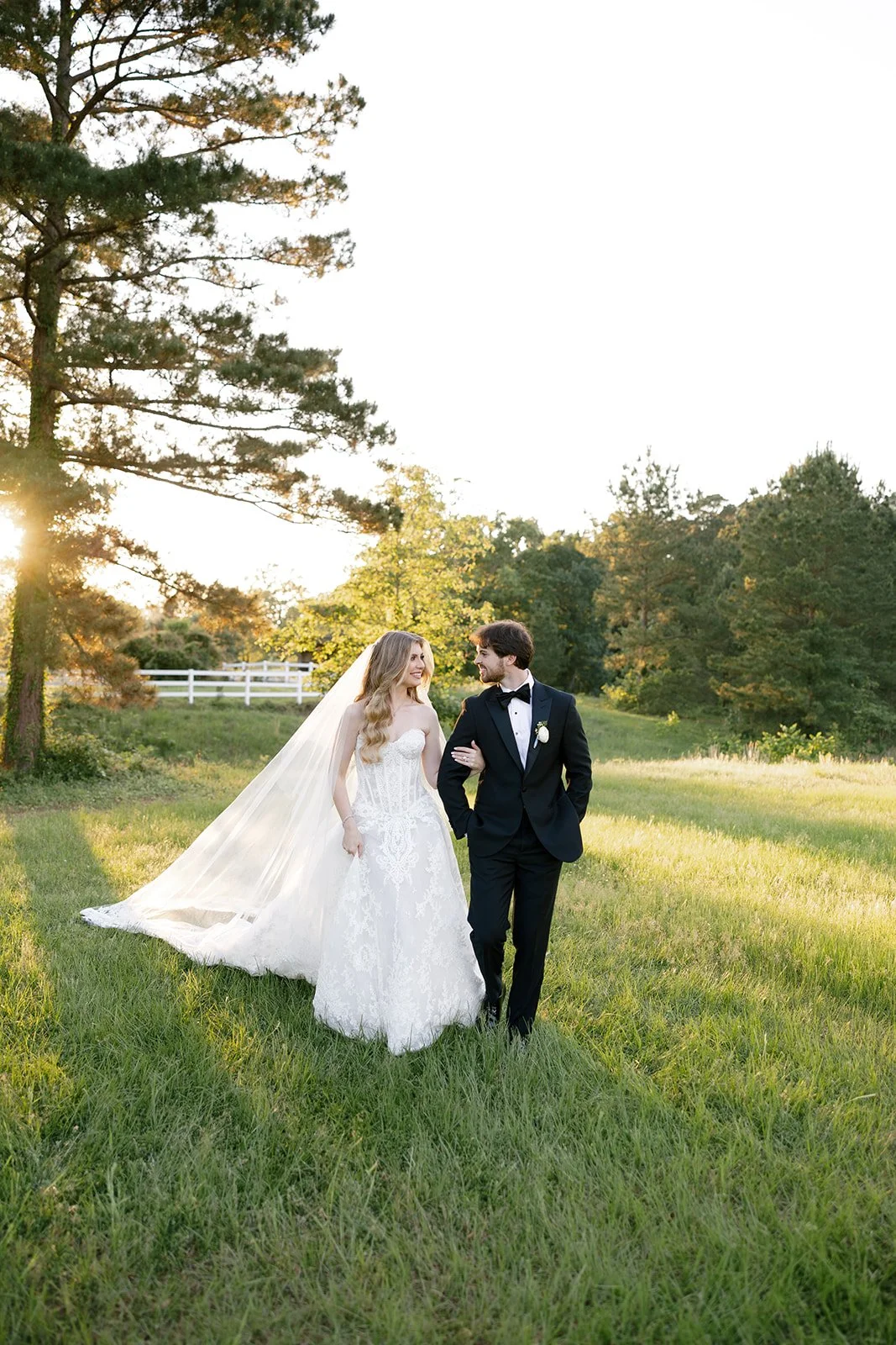 01-bride-and-groom-walking-through-a-field-in-golden-evening-light-at-the.jpg