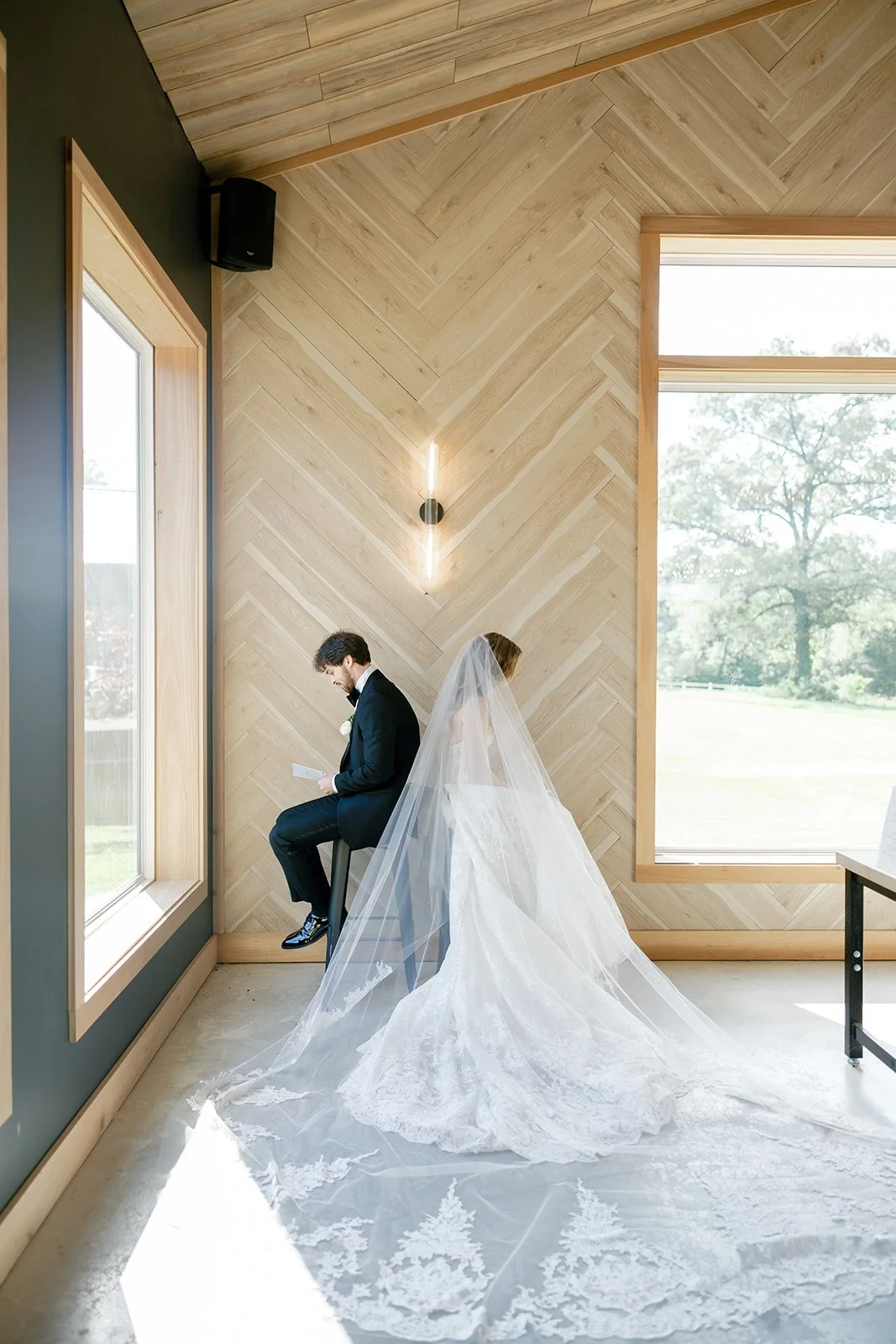 04-bride-and-groom-sitting-back-to-back-reading-private-vows-before-the.jpg